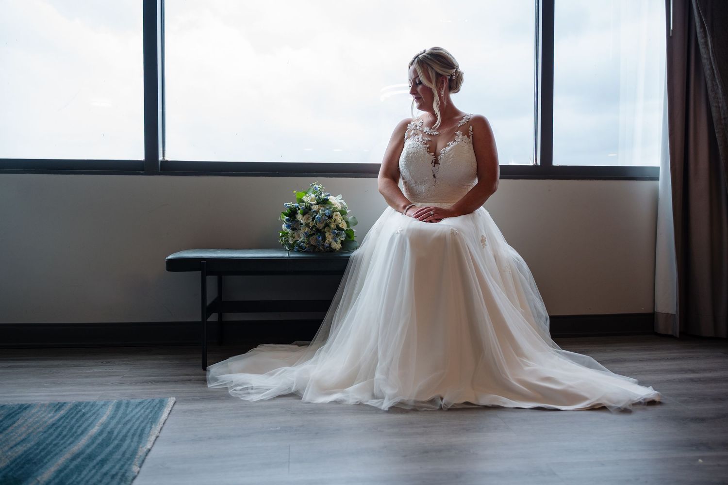 A sequence of elegant bridal portraits showing the bottom half of a white wedding dress against large windows.