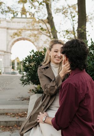 A couple in brown and burgundy outfits share joyful candid moments in a series of outdoor photos.