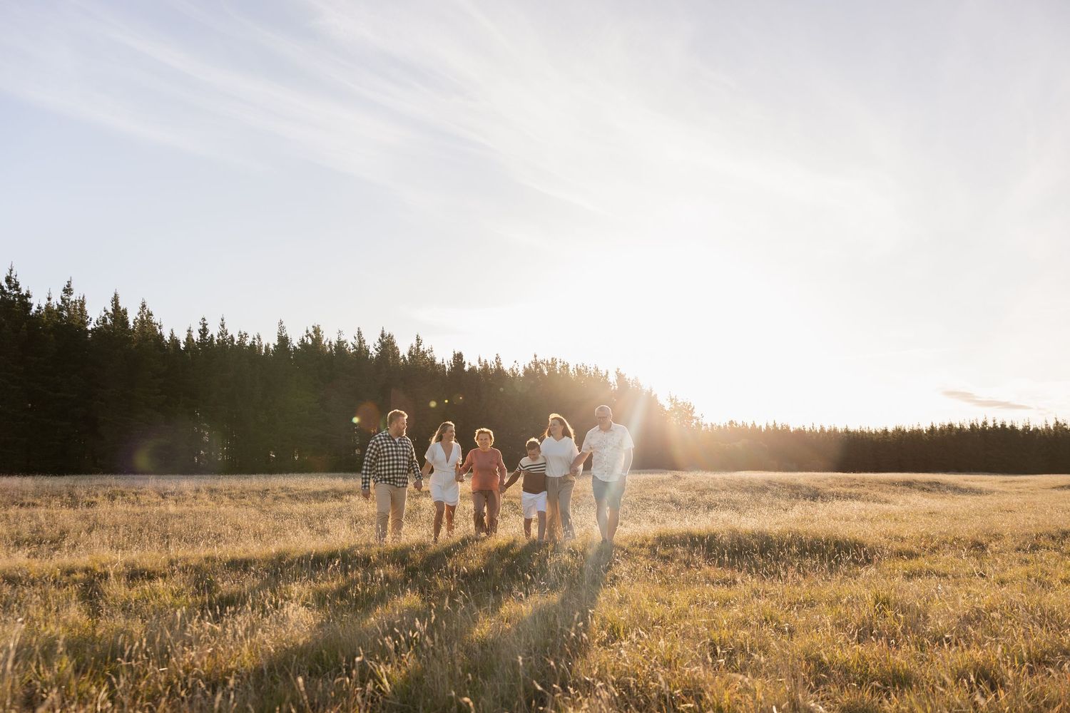extended family session during sunset, everyone holding hands walking towards me, Mcleans Island
