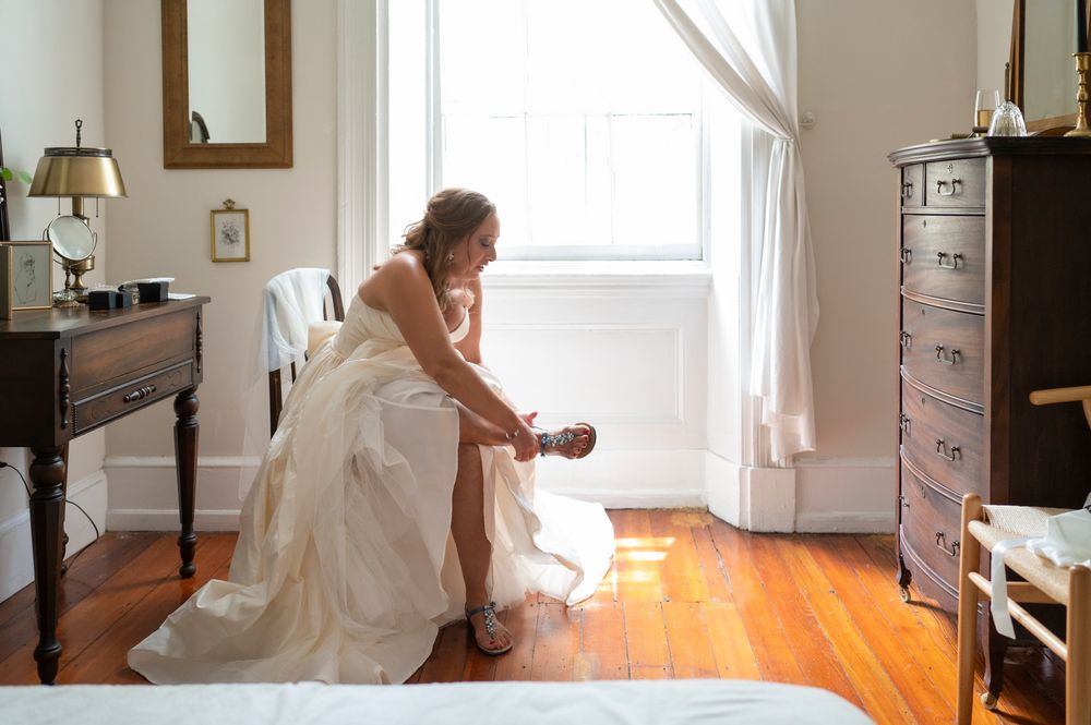 A series of photos showing someone in a white dress refinishing hardwood floors in a bright, sunlit room.