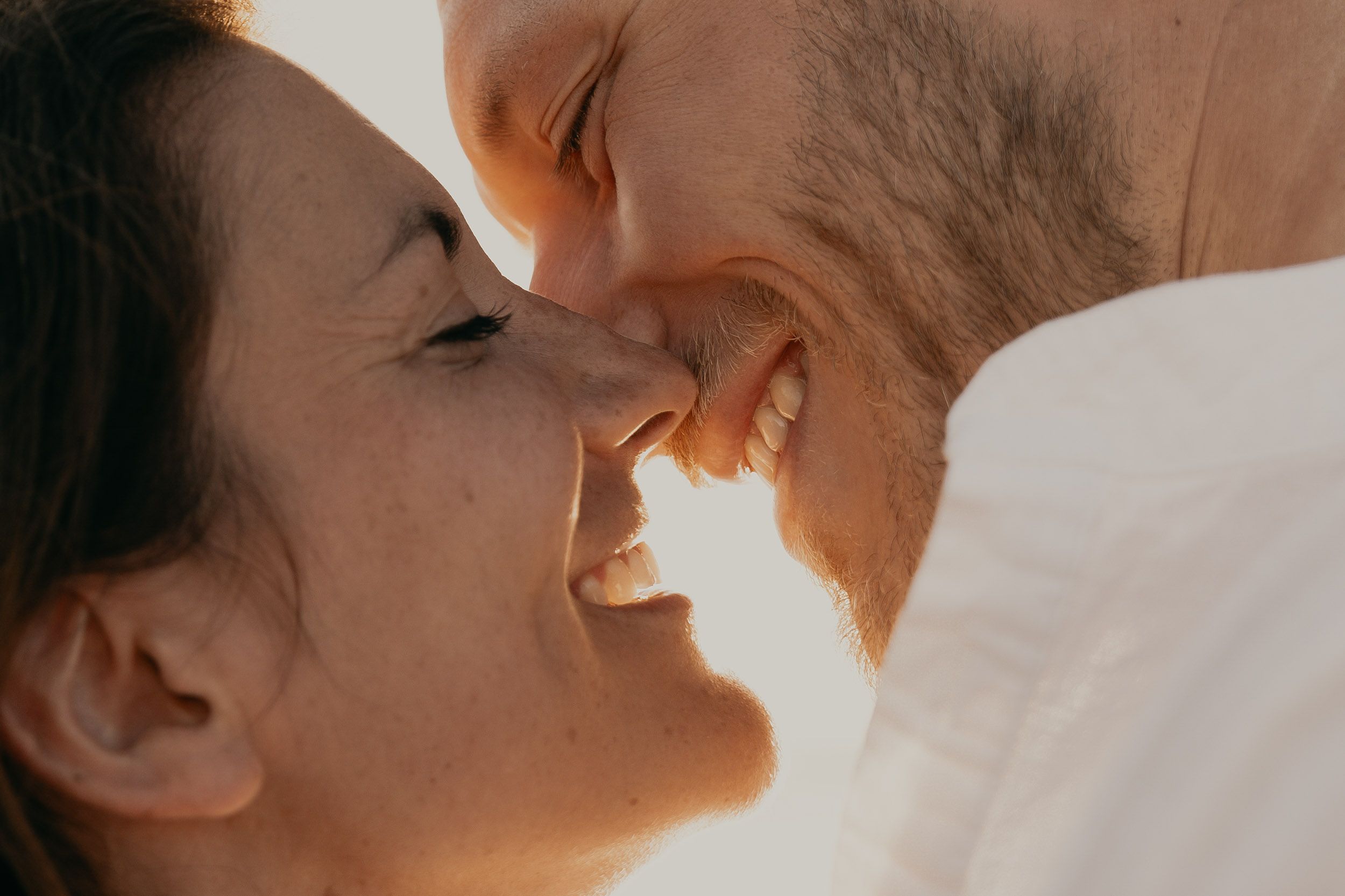 Intimate close-up photography with warm lighting and soft focus.