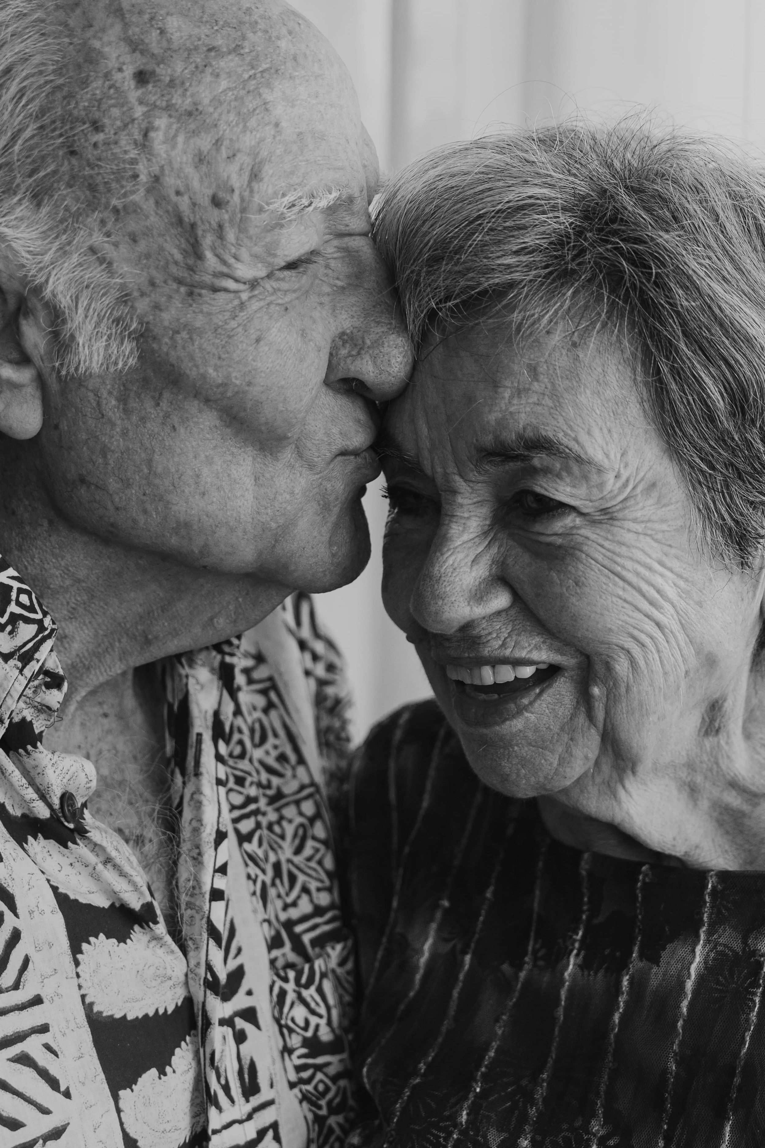 Black and white photo sequence showing tender moments between an elderly couple.