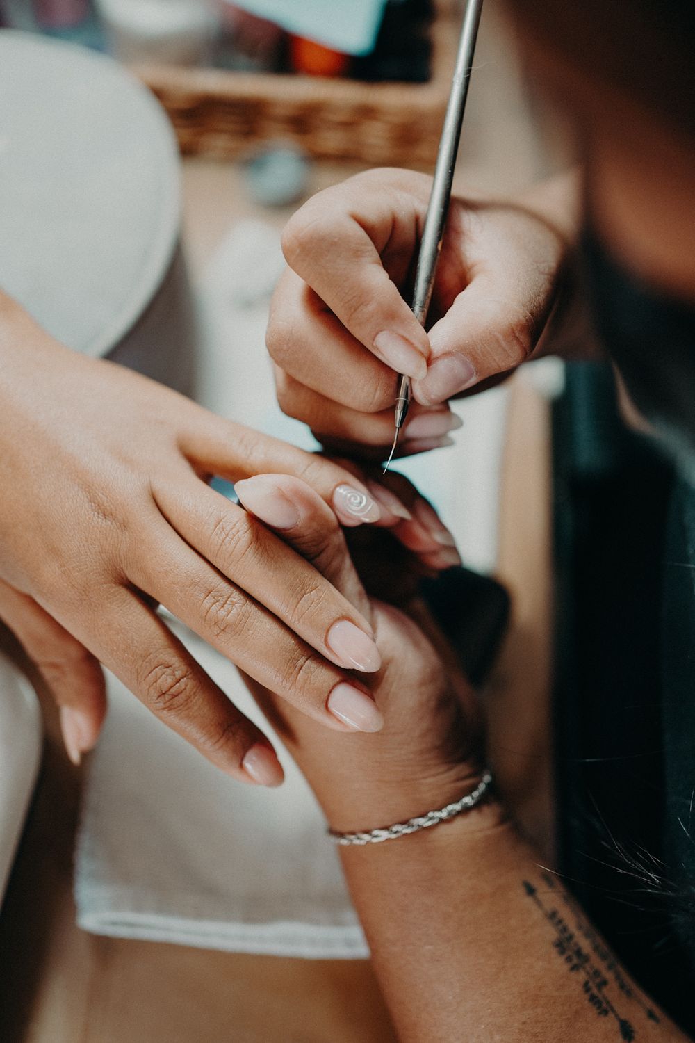 Close-up series of hands applying makeup with brushes and cosmetic products in professional beauty setting.