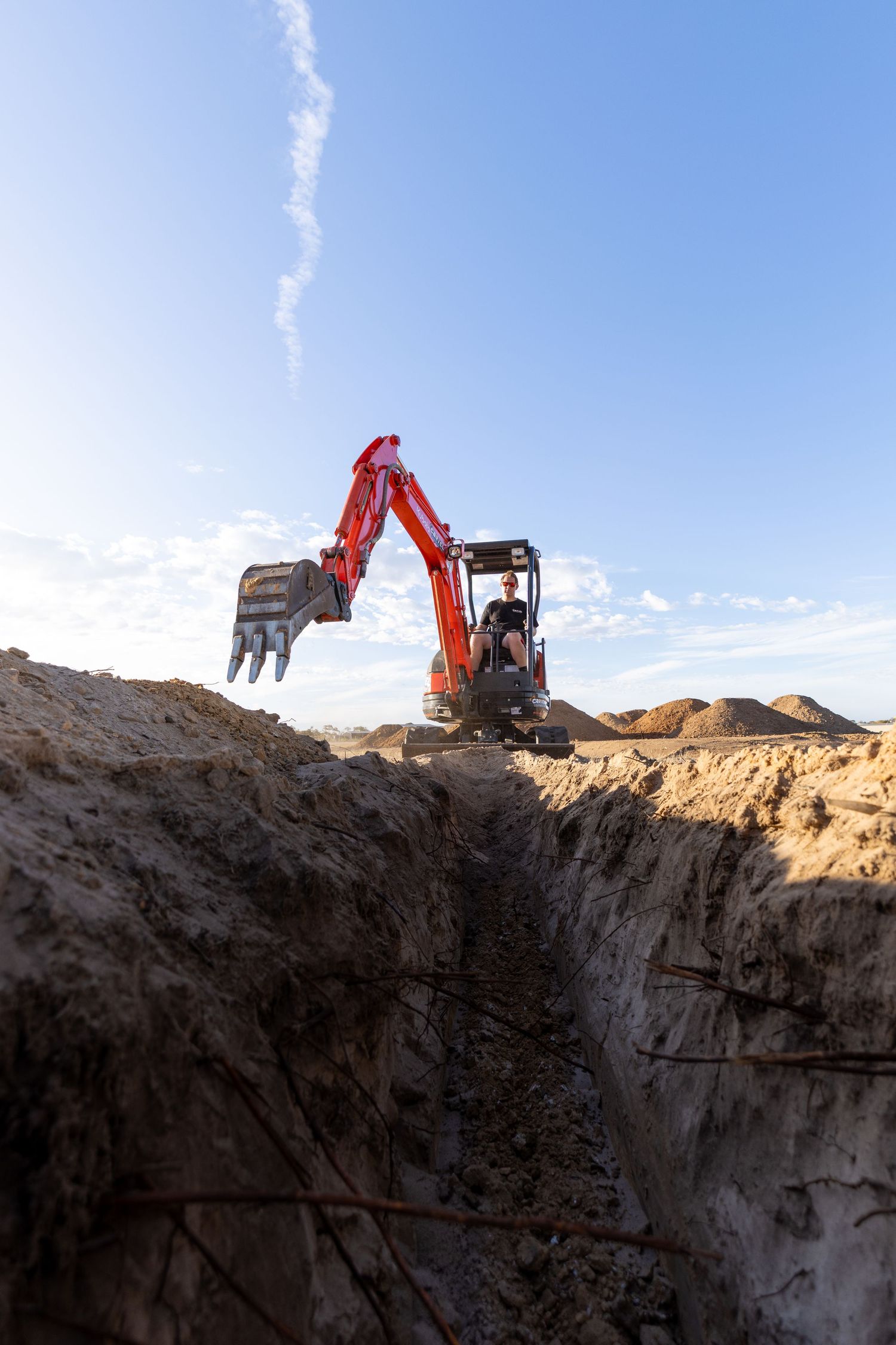 Mini excavator digging trench on site in Murray Bridge