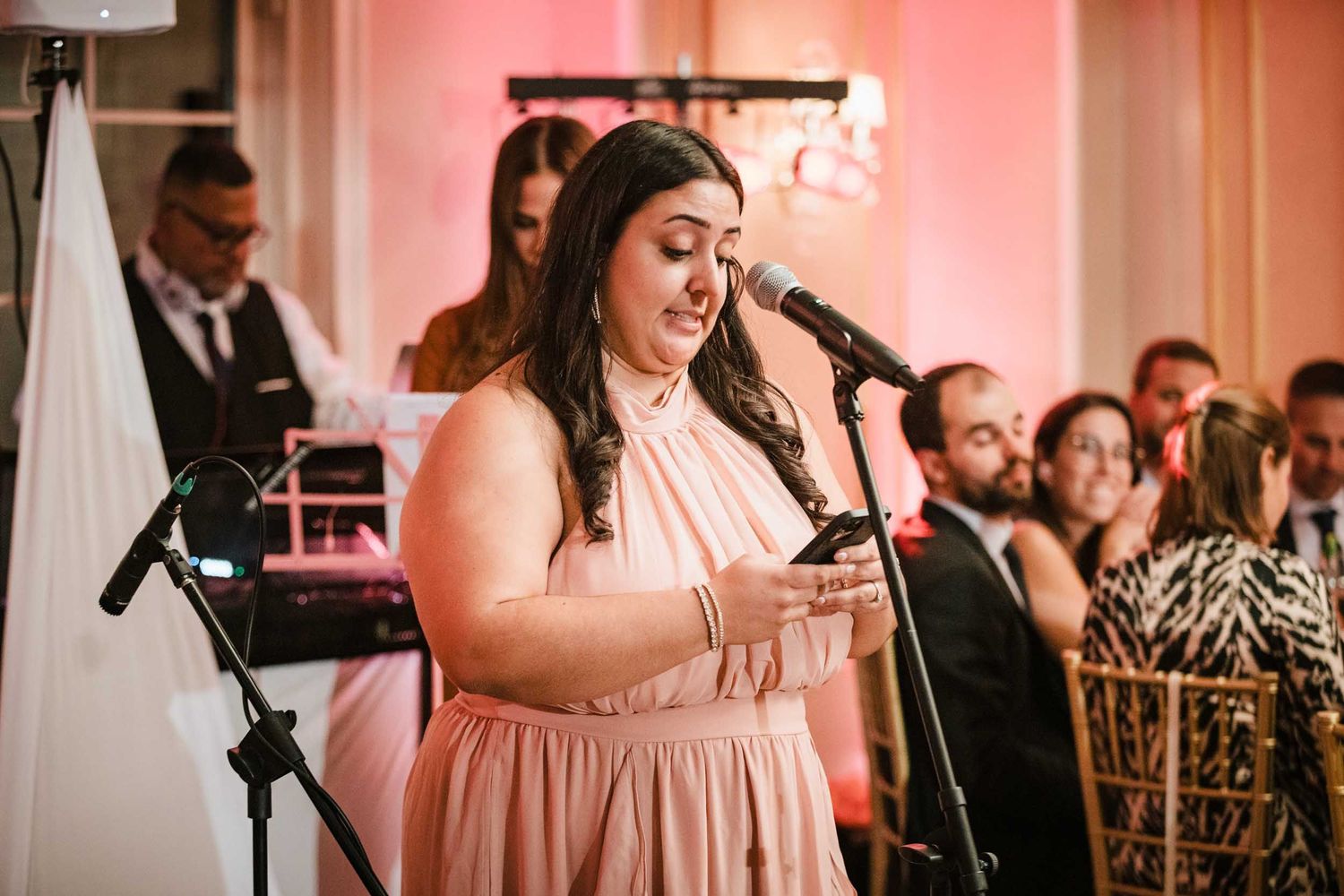 The maid of honor giving an emotional speech during a Lenox Hotel Boston wedding reception