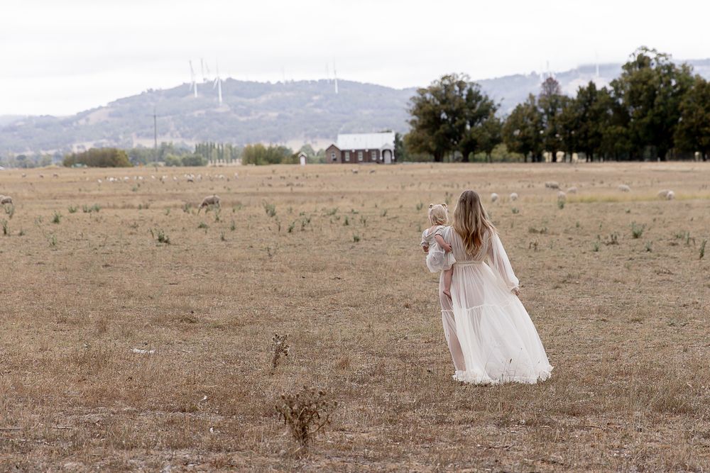 Mother to be and toddler in the paddock during a professional maternity photo shoot.
