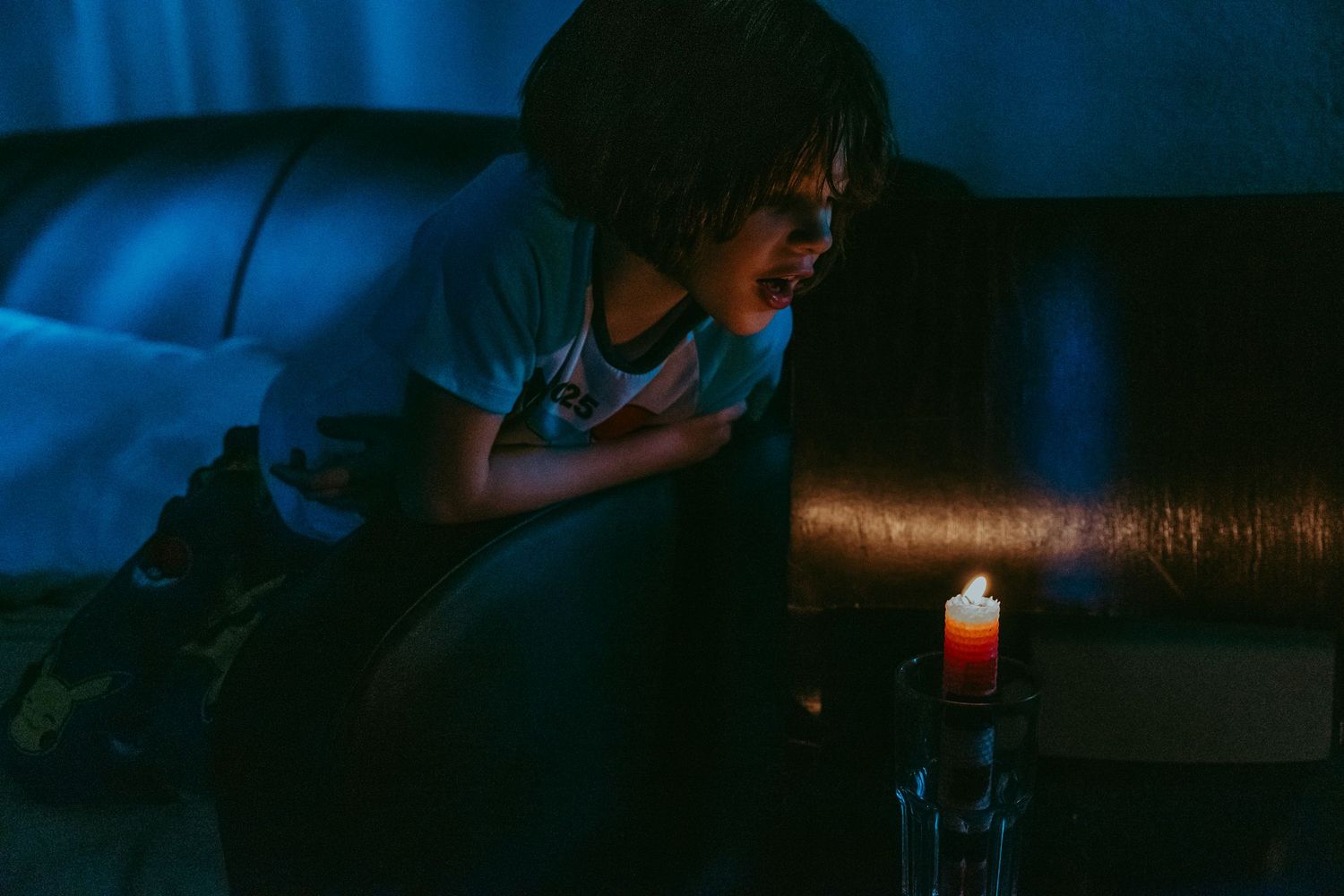 Child looking at candlelight in the evening. Whitney Popp, Popp Photography, Arizona.