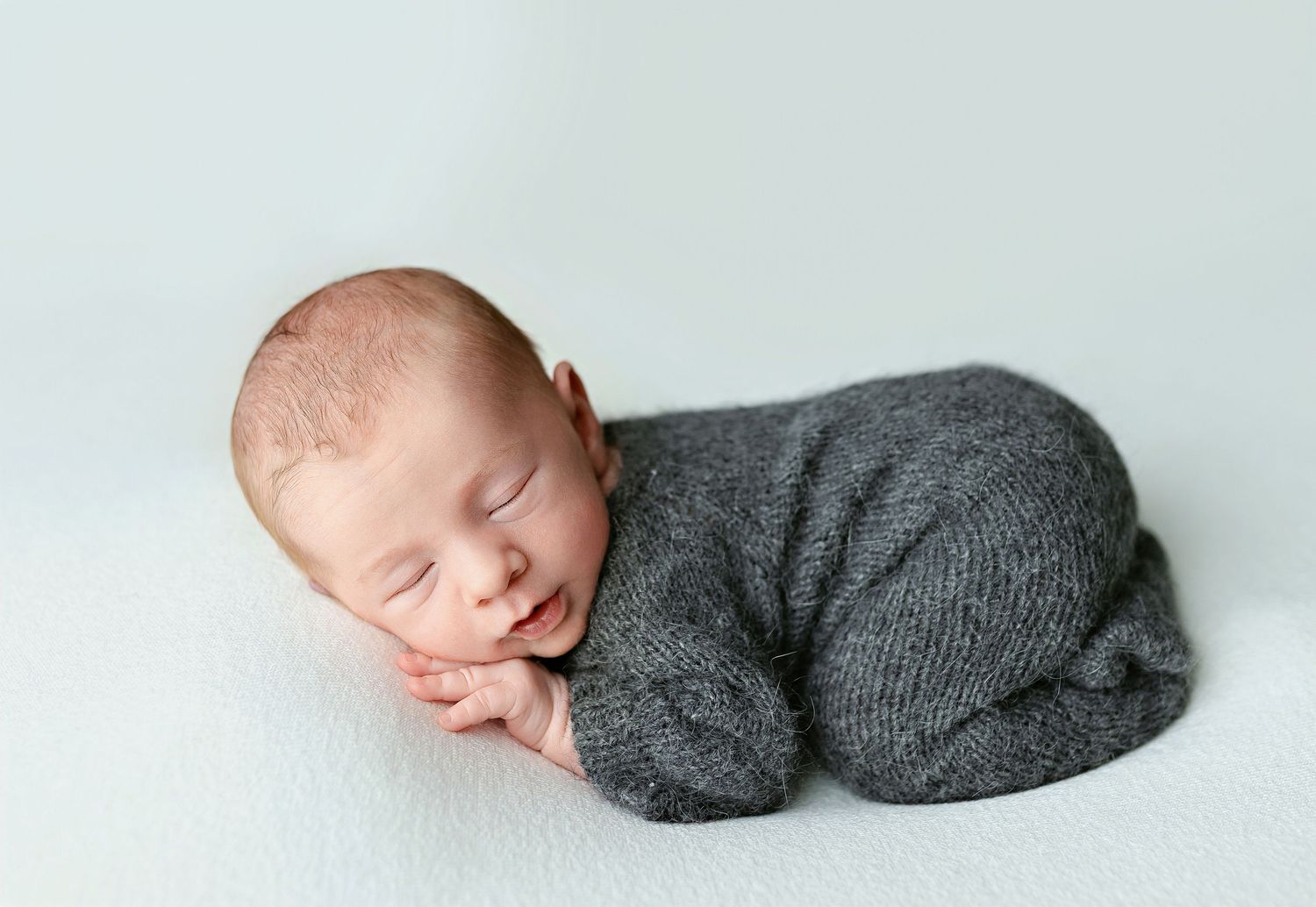 A newborn boy in gray outfit doing a bum- Greenville, SC newborn photographer, Easley SC newborn photographer, Upstate SC newborn photograph