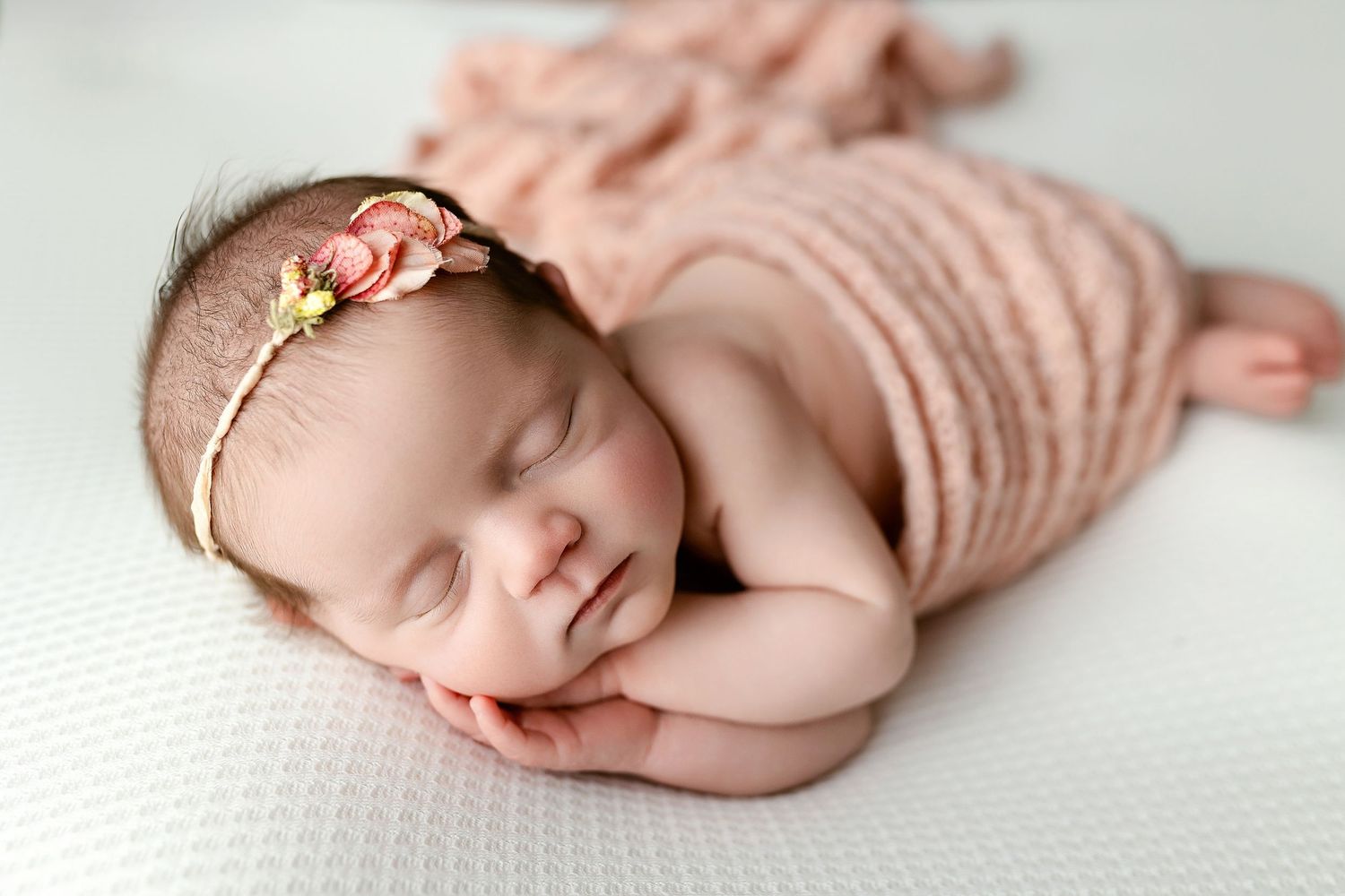 Newborn girl in pink wrap on side. Greenville, SC newborn photographer, Easley SC newborn photographer, Upstate SC newborn photographer.