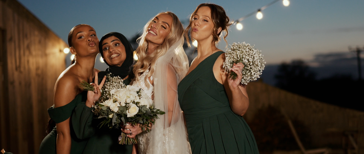 Wedding party celebrates outdoors during golden hour with joyful expressions.