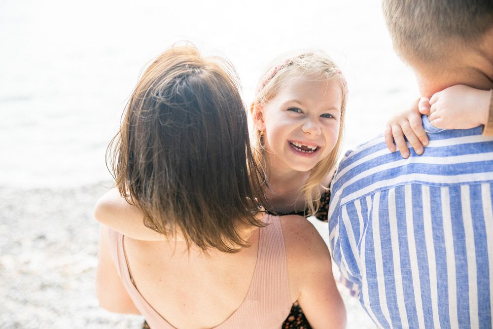 A joyful beach moment captured during golden hour with the sun behind.