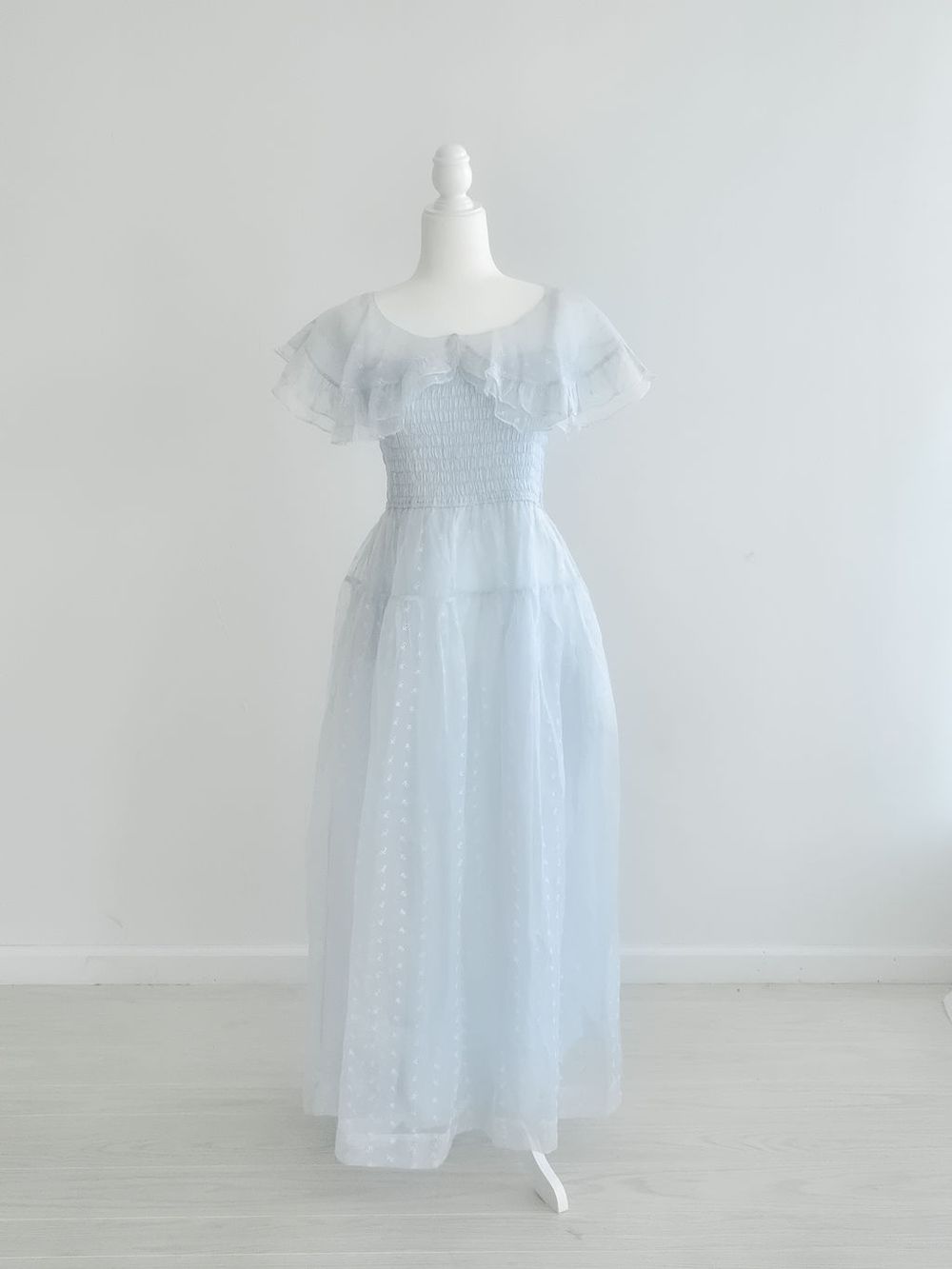 Light blue ethereal maxi dress with short flutter sleeves and dotted tulle overlay.