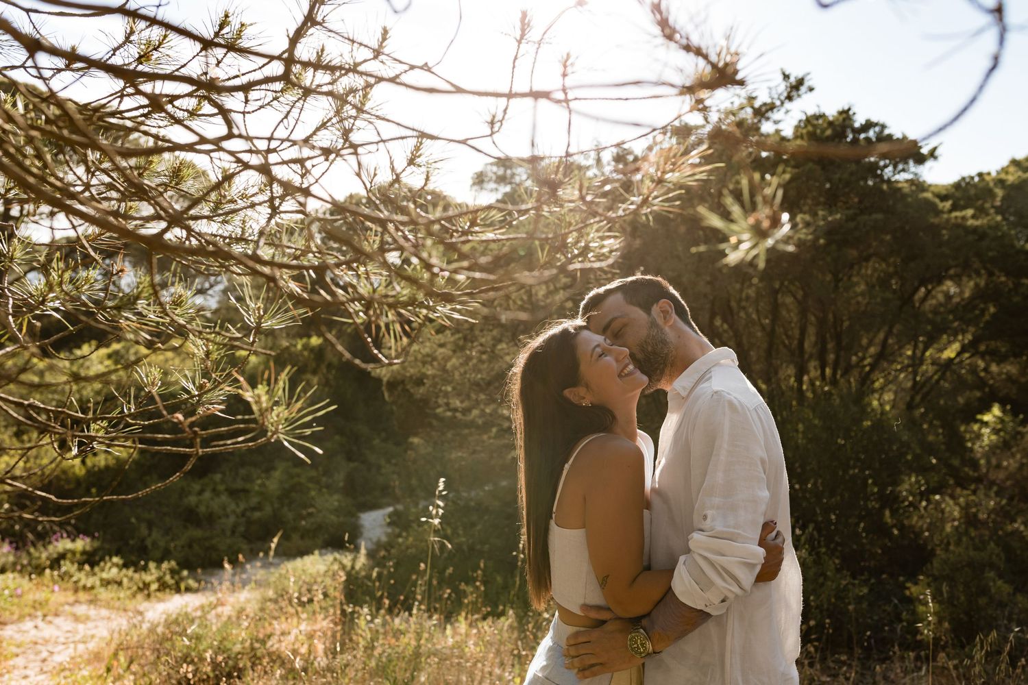 engagement session in Lisbon at Fonte da Telha with couple hugging under pine trees