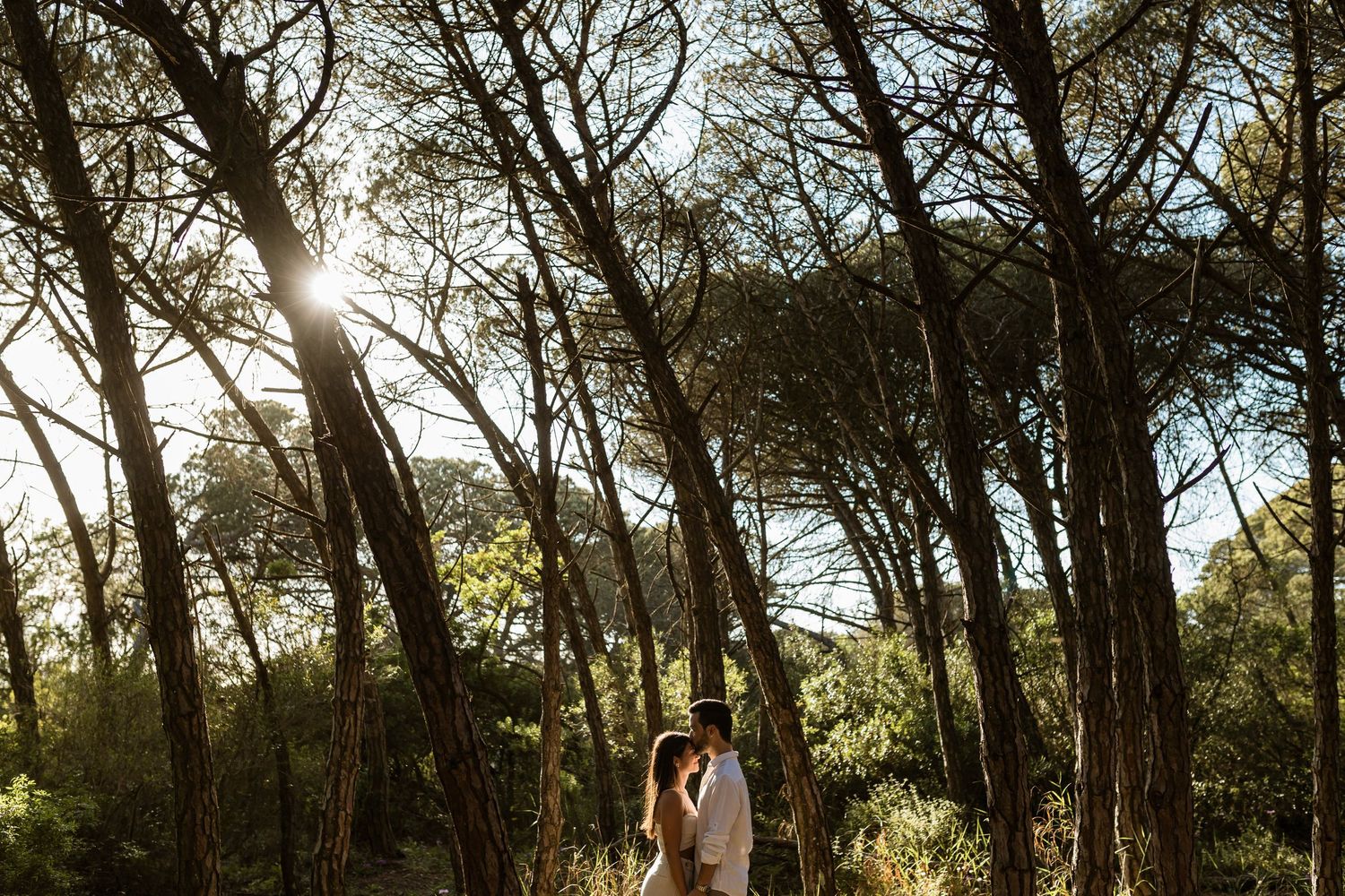 pre-wedding photoshoot in Lisbon forest near Fonte da Telha with couple standing together