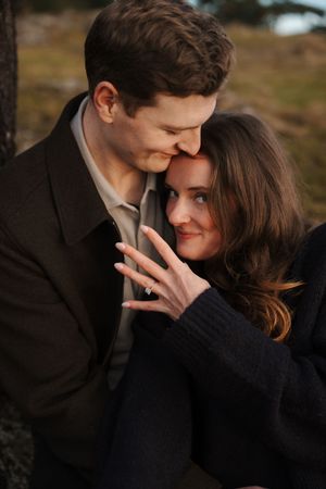 A romantic couple shares intimate moments in a series of black and white outdoor portrait photographs.