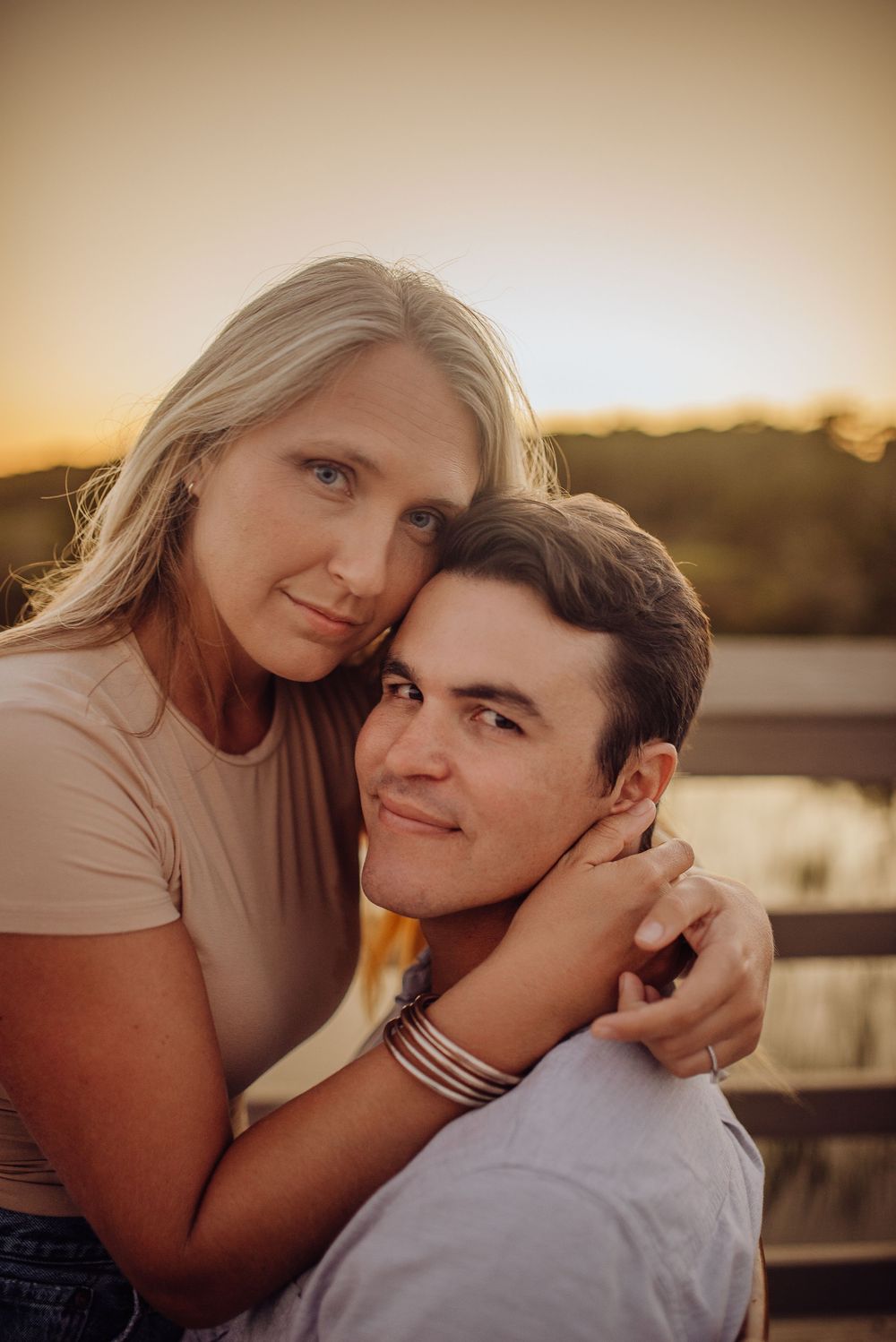 A couple shares intimate moments at sunset in a series of romantic outdoor portrait photos.
