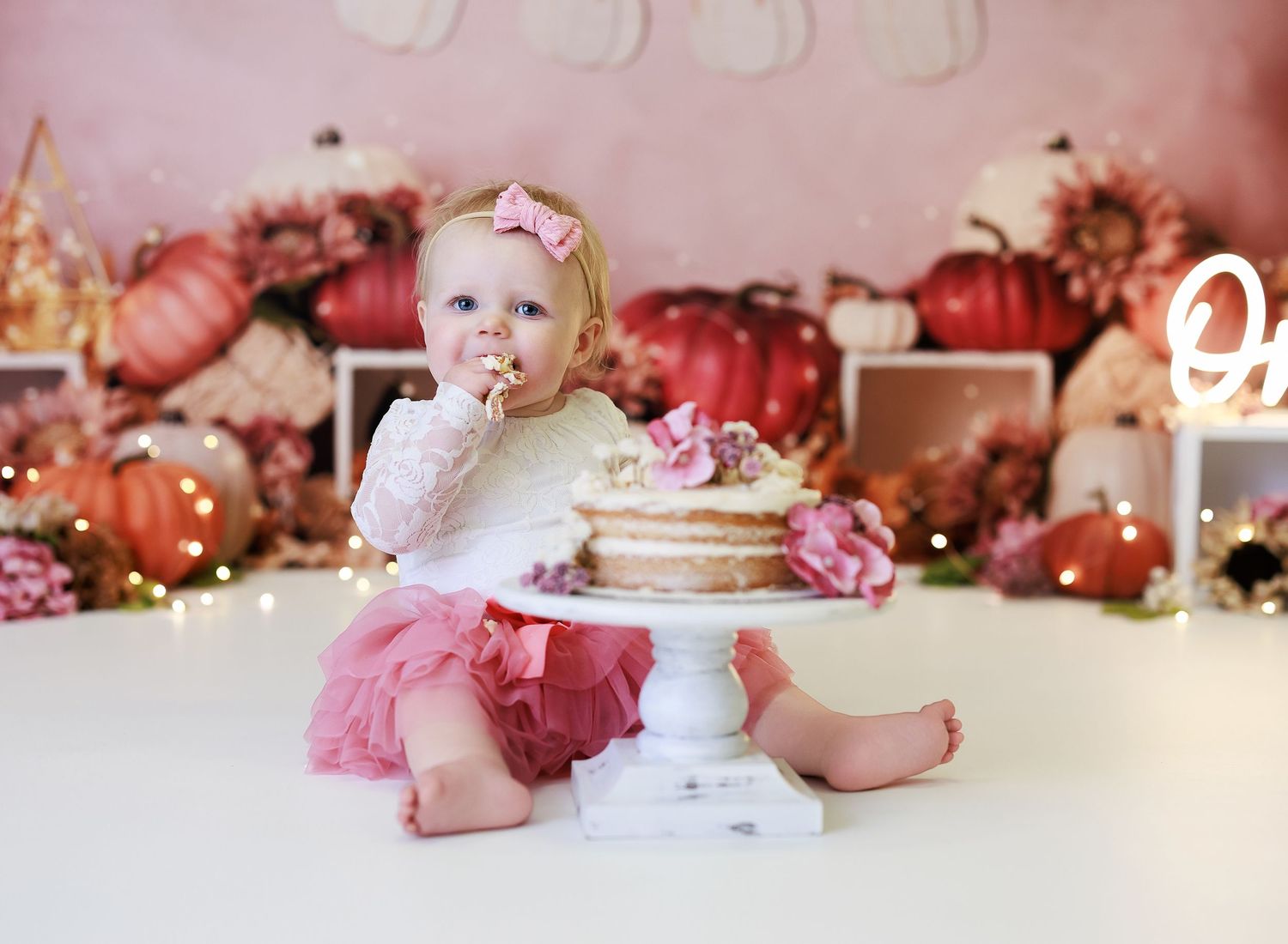 1 year old cake smash session with a pumpkin theme