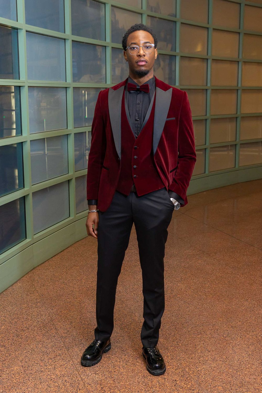 A series of photos showing burgundy velvet formal wear against a green institutional hallway background.