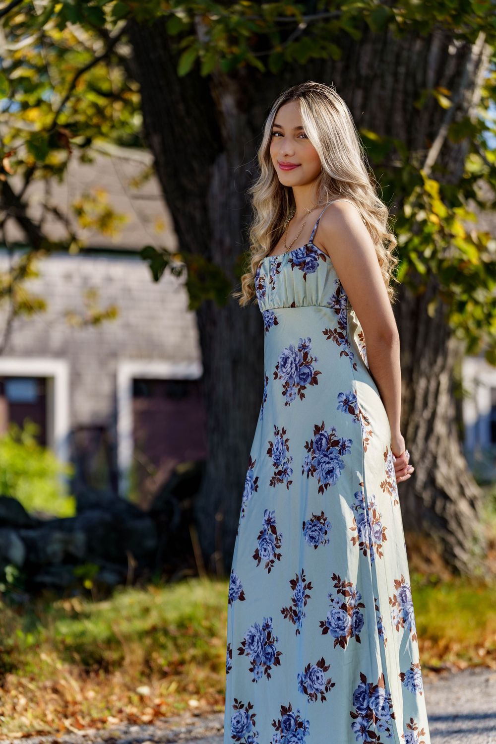 Light blue floral sundress with purple blooms shown from multiple angles in an outdoor autumn setting.