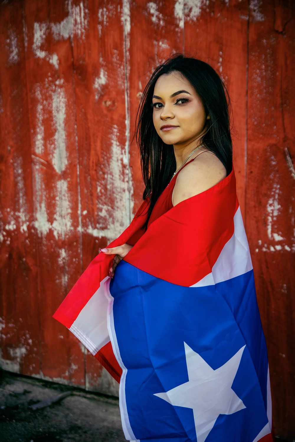 A series of photos showing a person posing with a Puerto Rican flag against a rustic red wall background.