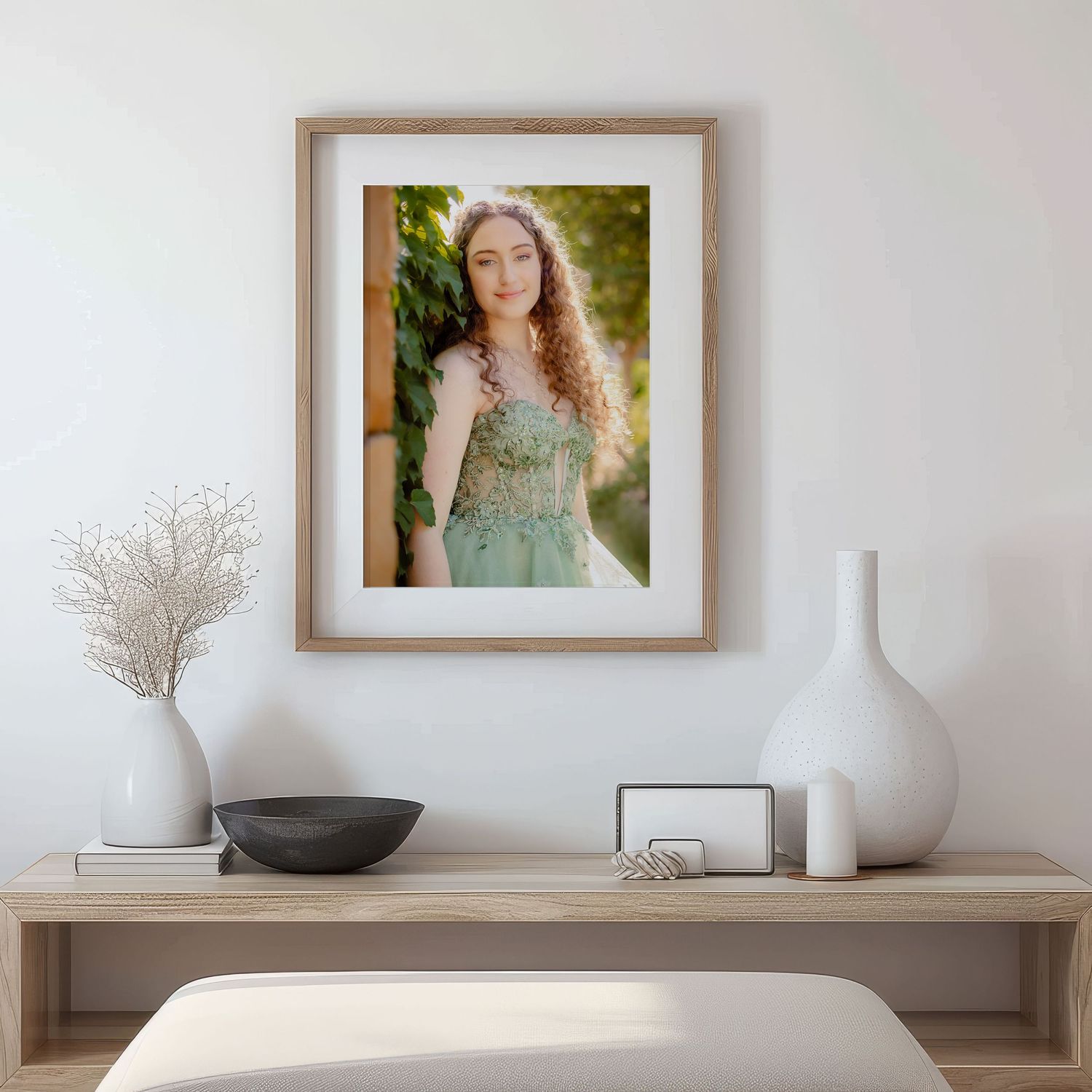 Framed portrait photograph displayed on shelf with minimalist white vases and dried pampas grass decor in Grapevine, TX.