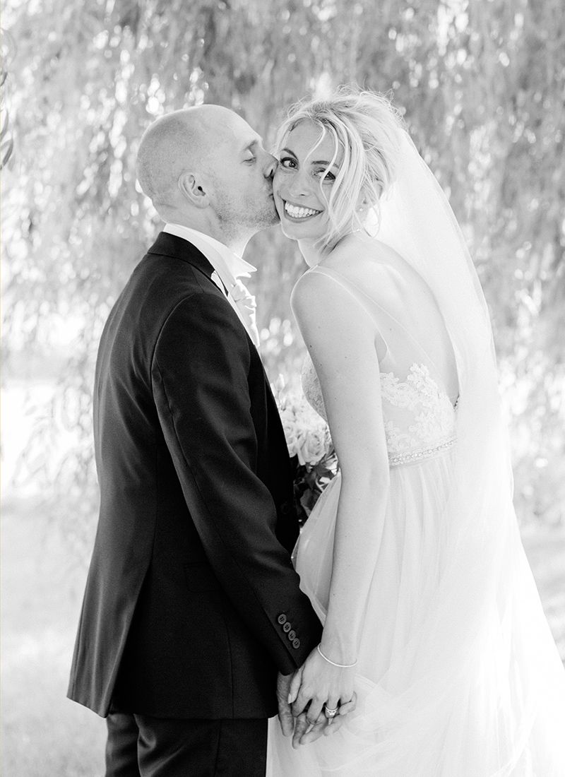 Elegant wedding couple portrait at a French château with soft natural light and timeless black and white editorial style