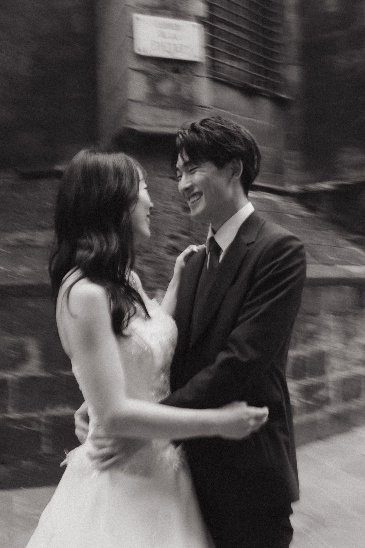 A romantic black and white photo sequence shows a couple dancing and twirling together at their wedding celebration.