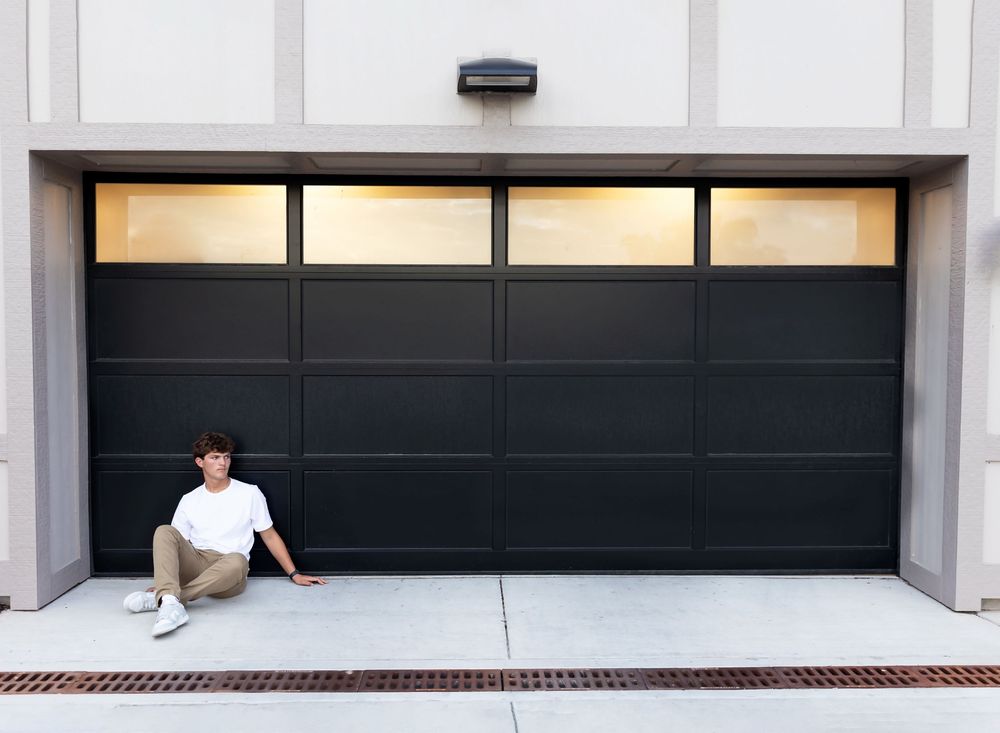 A series of four images showing a garage door being opened gradually from closed to fully raised position.