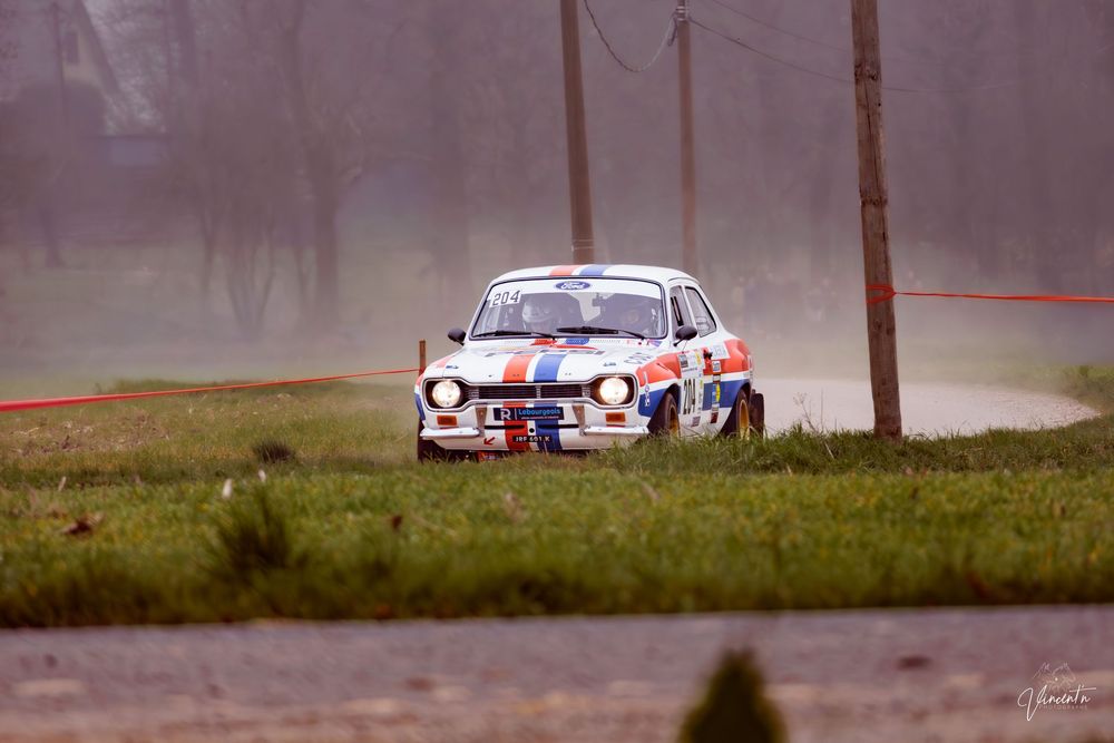 Rally car racing through foggy forest course with white and red livery visible through multiple action shots.