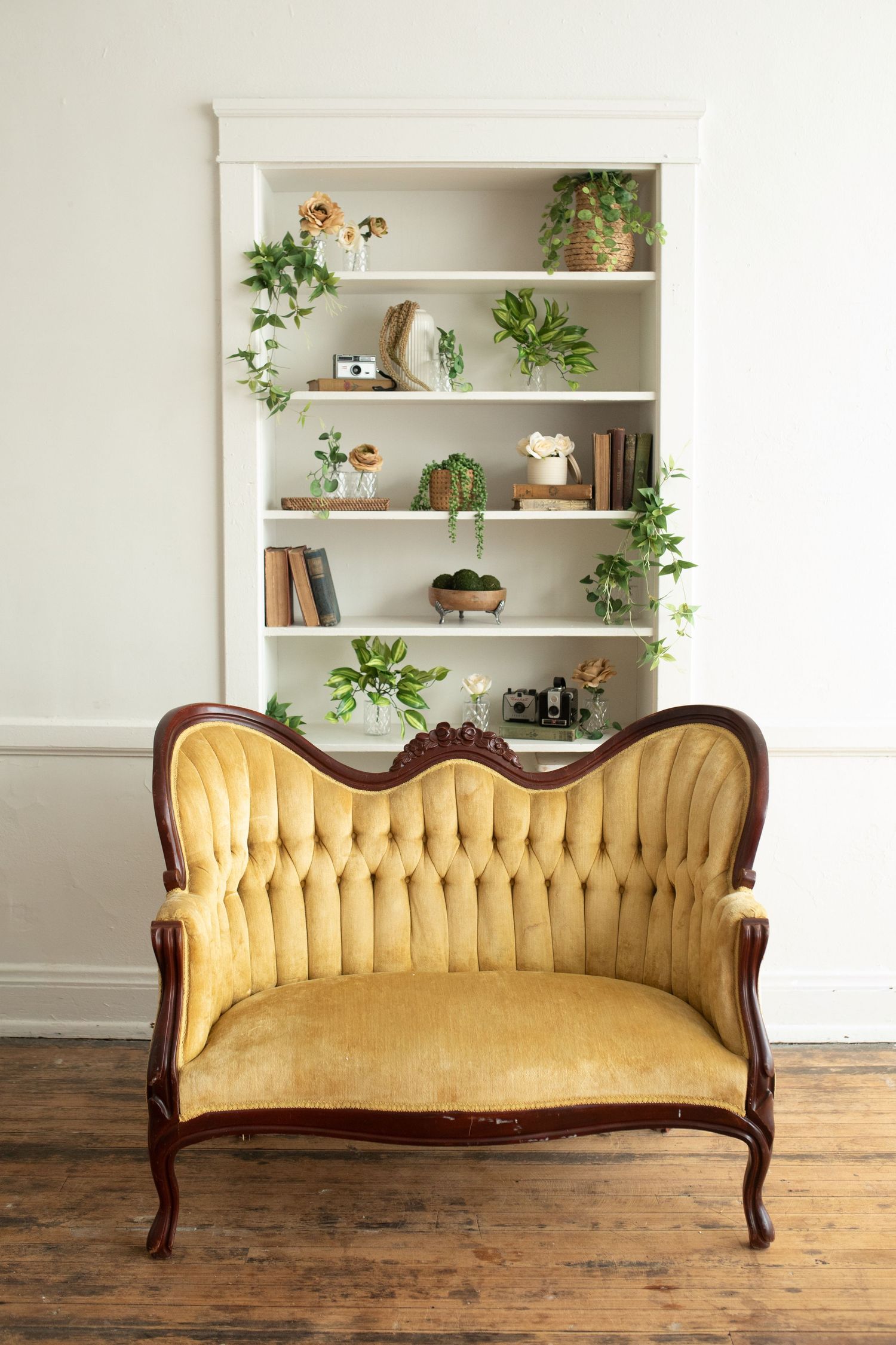 Vintage gold velvet Victorian sofa photographed from four angles against a white wall with built-in shelving.