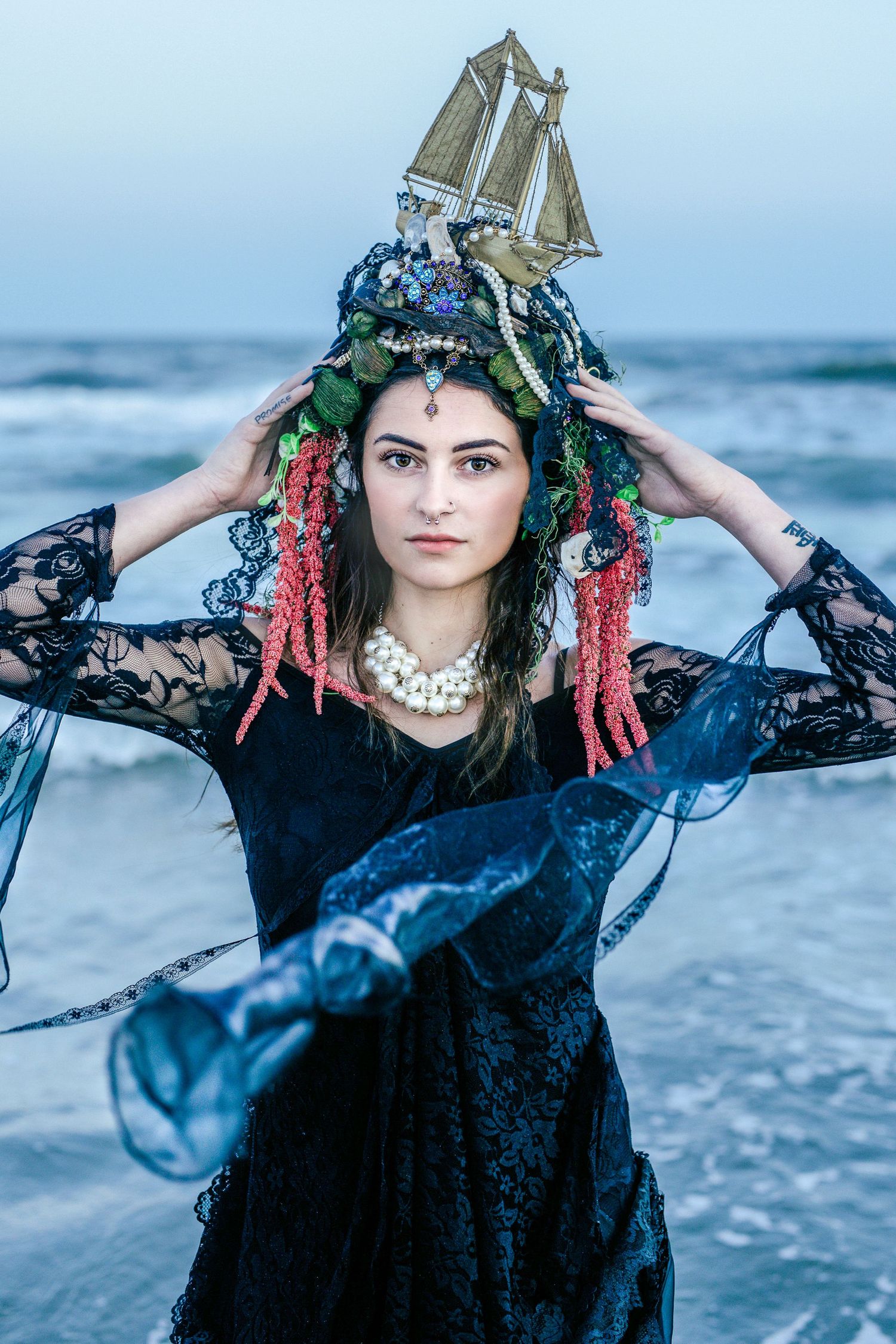 Dark fantasy beach portrait with ship crown, black dress, creative sunset photo shoot in Amherstburg, Ontario.