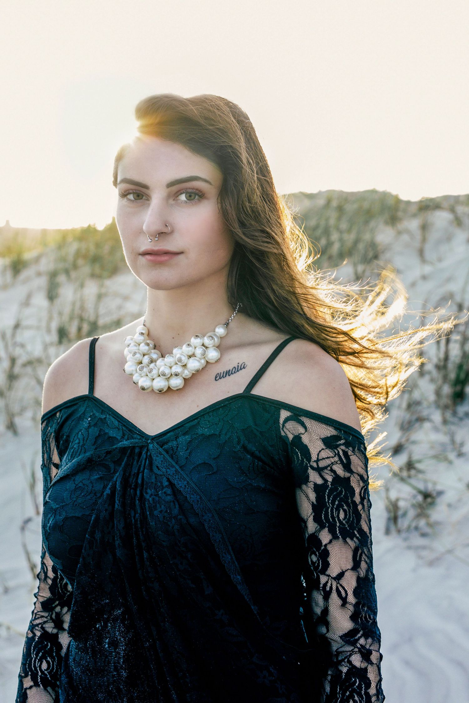 Golden hour beach session with a woman in a black dress, romantic and moody portrait – Southern Ontario coast.