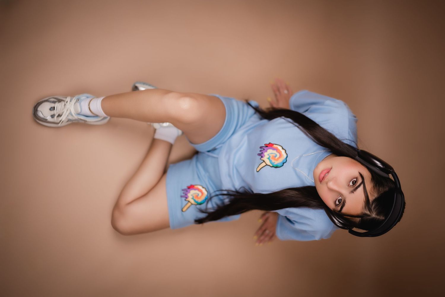 Stylized portrait in blue uniform with patches lying on brown backdrop.