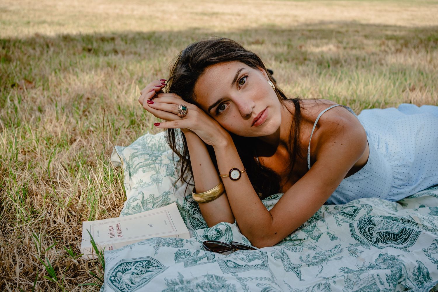 Artistic still life composition with small objects against a light gray background.