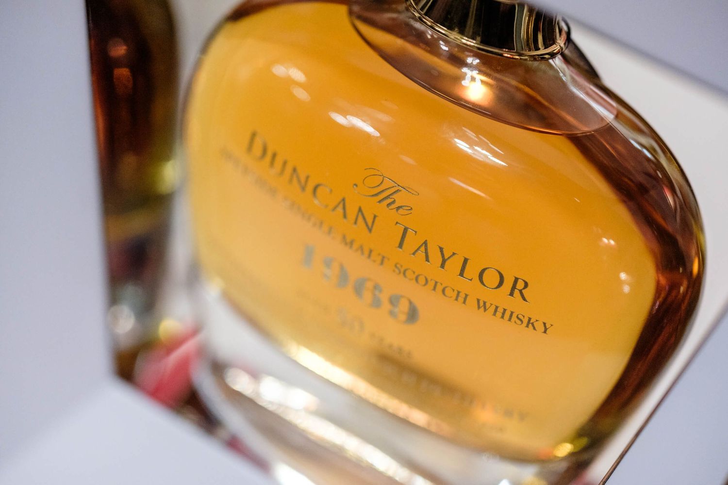 Close-up shots of a whiskey bottle label showing 'E.H. Taylor' text against a warm amber background.