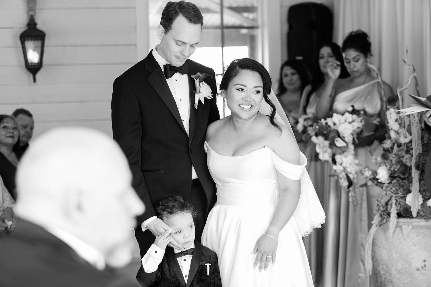 Black and white wedding photos show joyful dancing and celebration moments at an elegant reception venue.