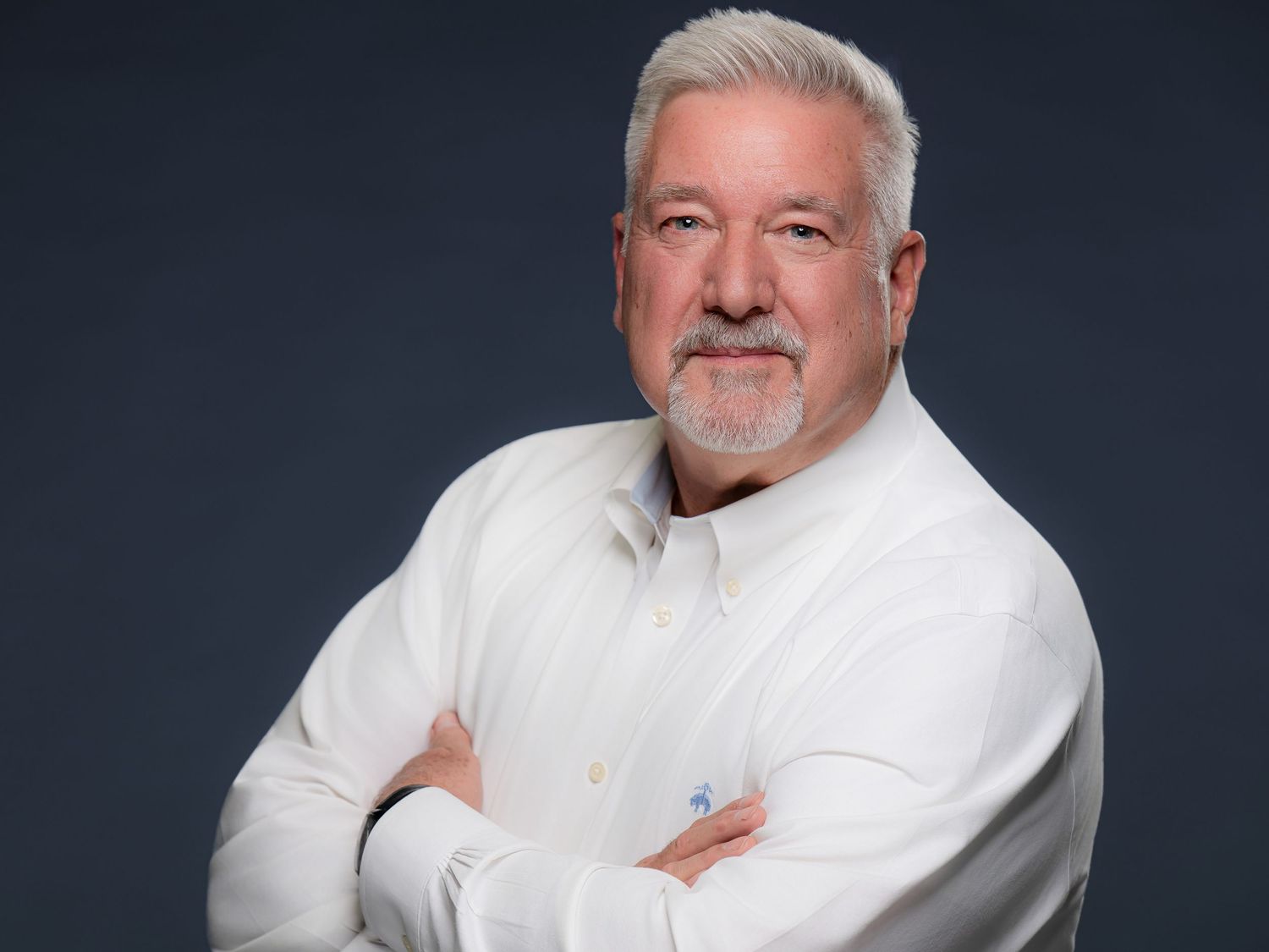 Professional headshots of a chef in a white coat against a dark background shown from different angles.