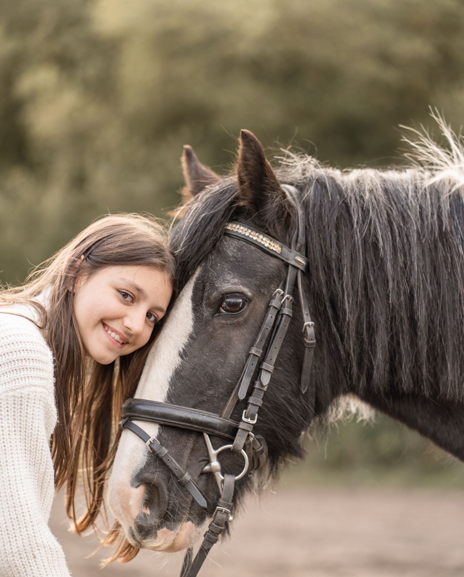 A person and a black horse share a tender moment outdoors, showcasing their special bond and connection.