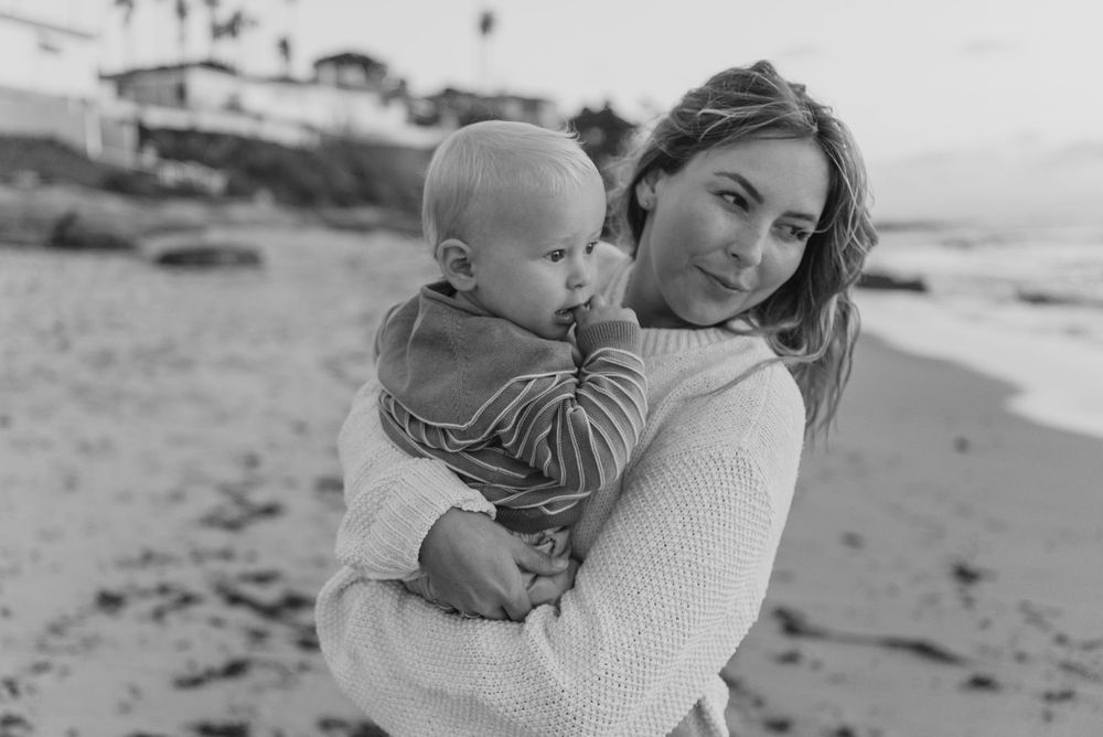 Windansea Beach family photos in San Diego with playful, candid moments by the ocean.