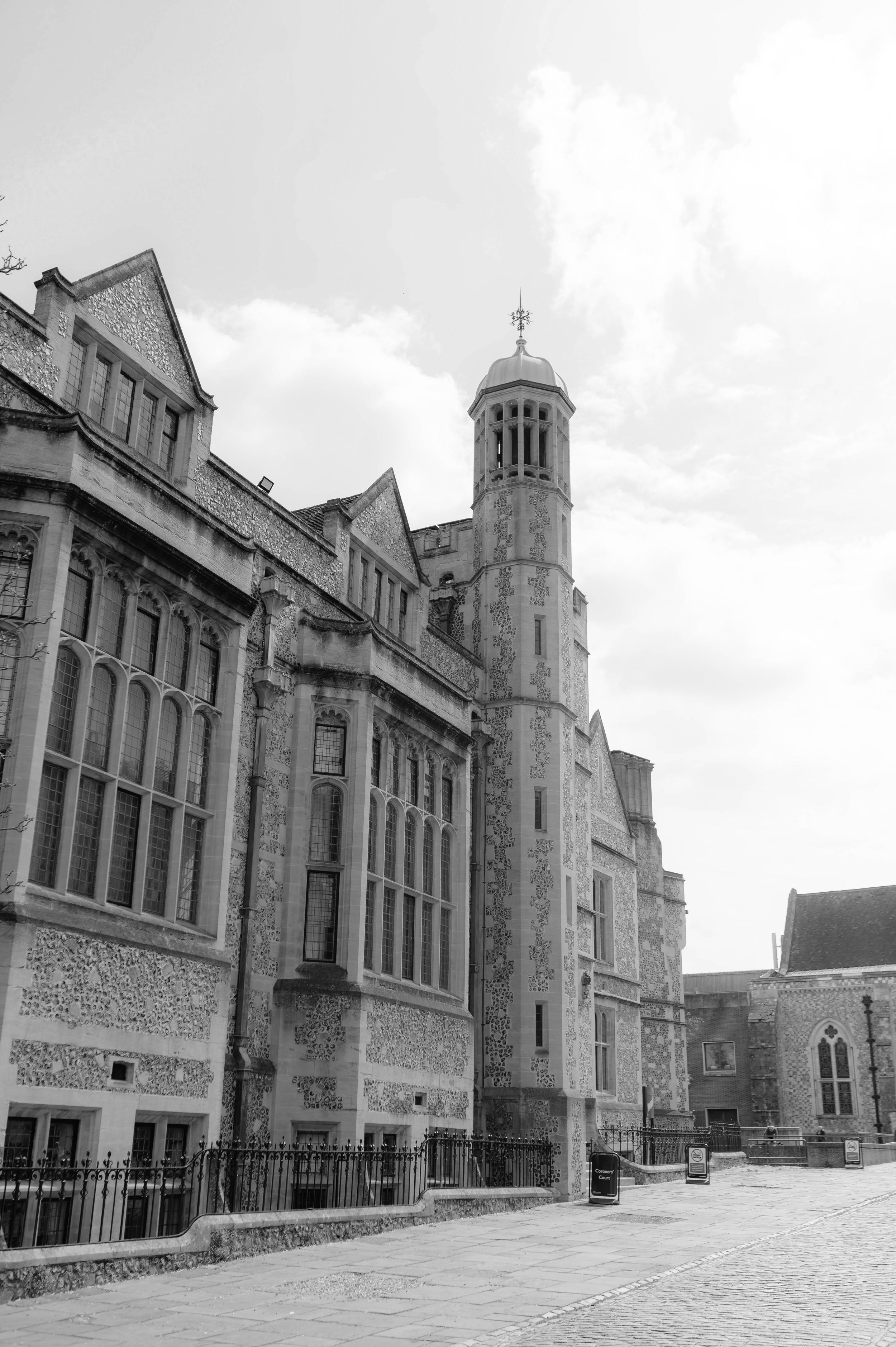 Historic stone church building with Gothic architectural features and tall spires viewed from multiple angles in black and white.
