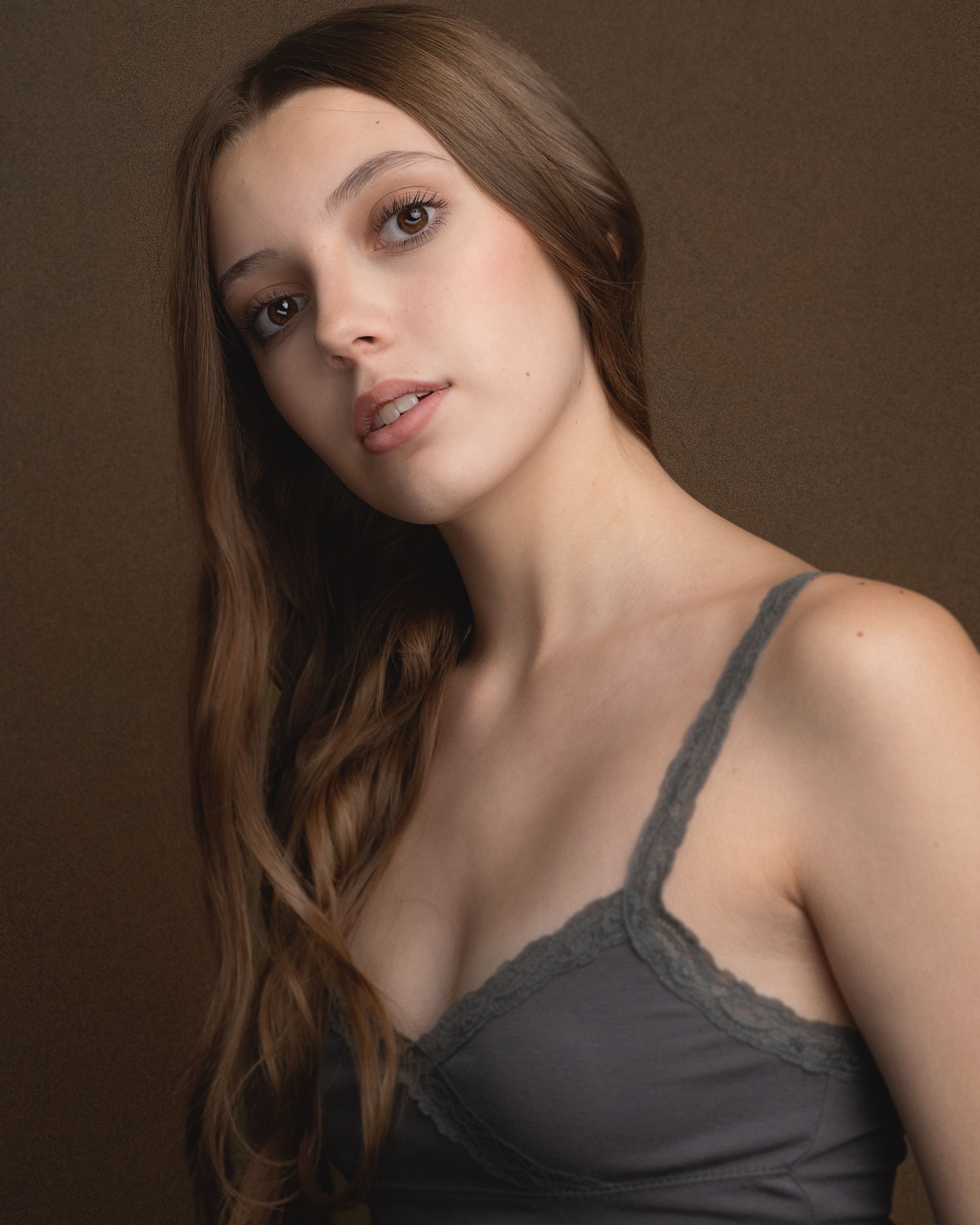 Portrait series showing different poses and angles in dramatic lighting against dark background.
