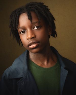 Portrait series showing different expressions and angles in dramatic lighting against a dark brown background.
