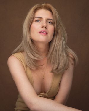 A series of portrait photos showing a woman with blonde hair in a brown top against a dark brown backdrop.
