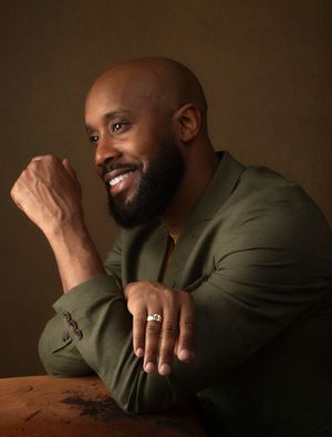 A series of four moody portraits showing a person in an olive green blazer posing thoughtfully against a dark background.