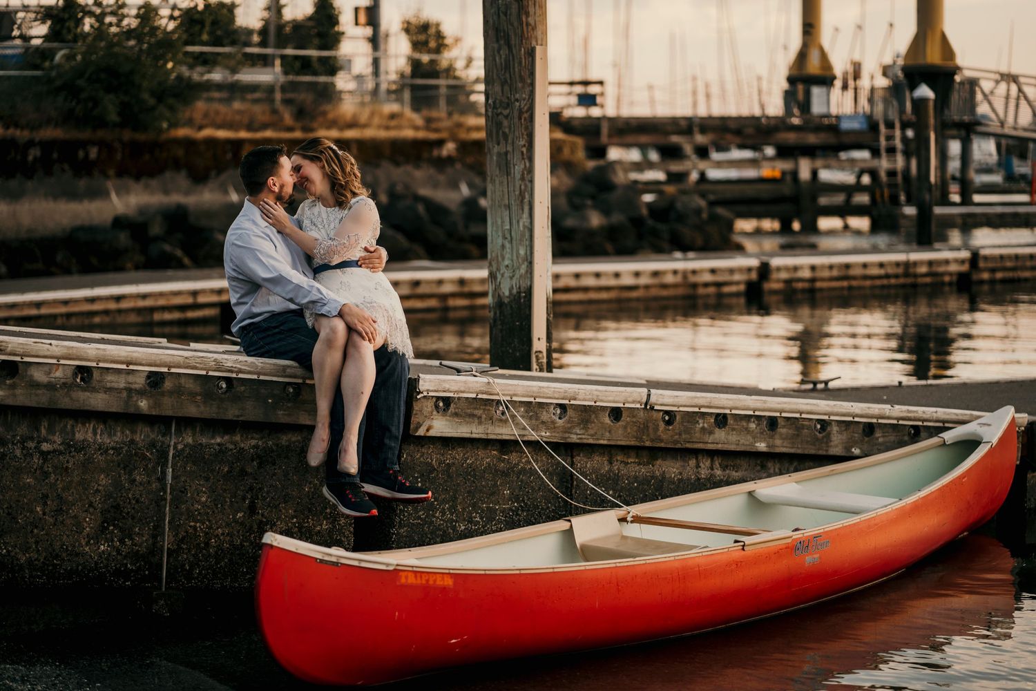 Couple posing on the deck at Golden Gardens Park Seattle WA for engagement photos