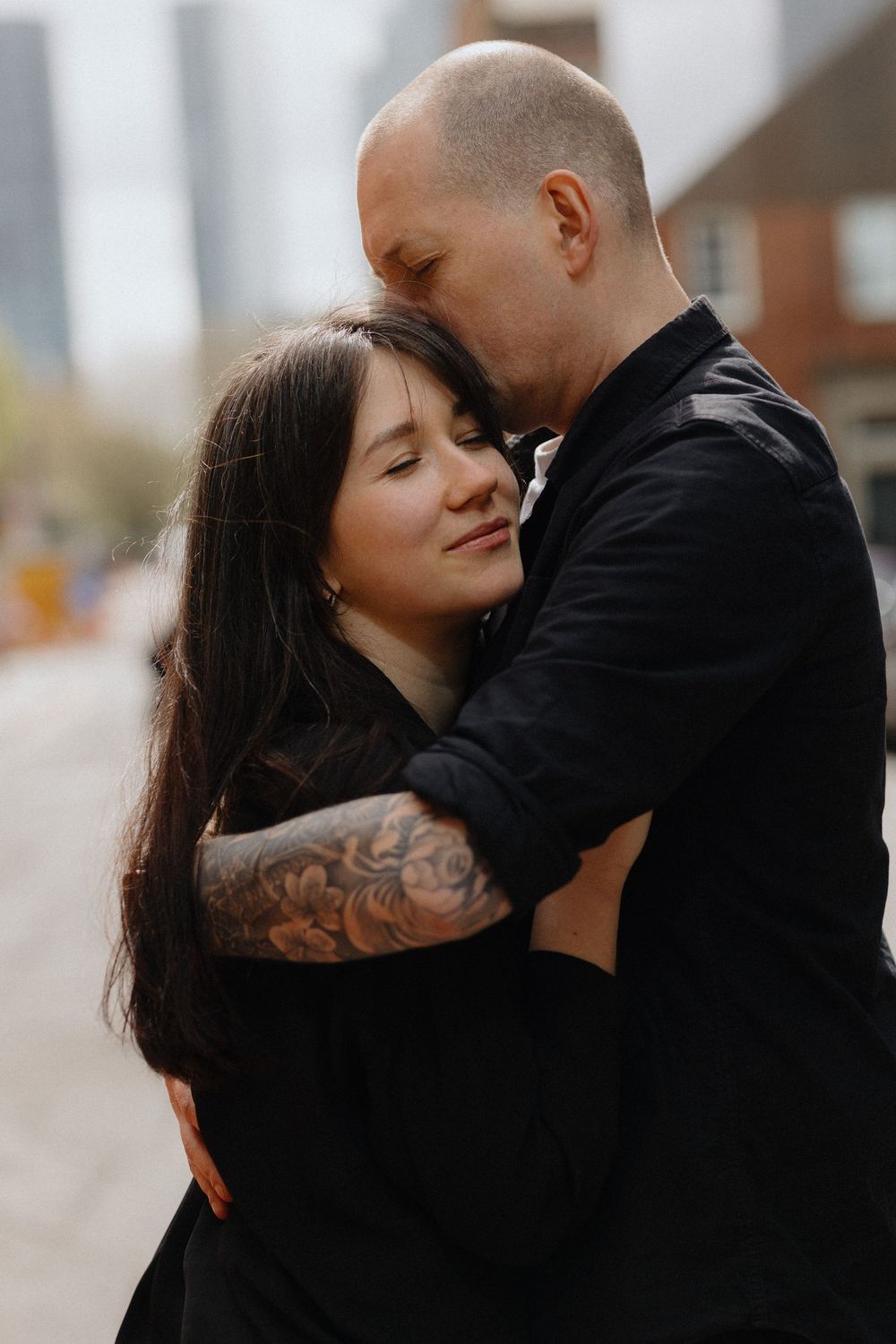 A romantic couple embraces tenderly in a series of intimate black and white portraits.