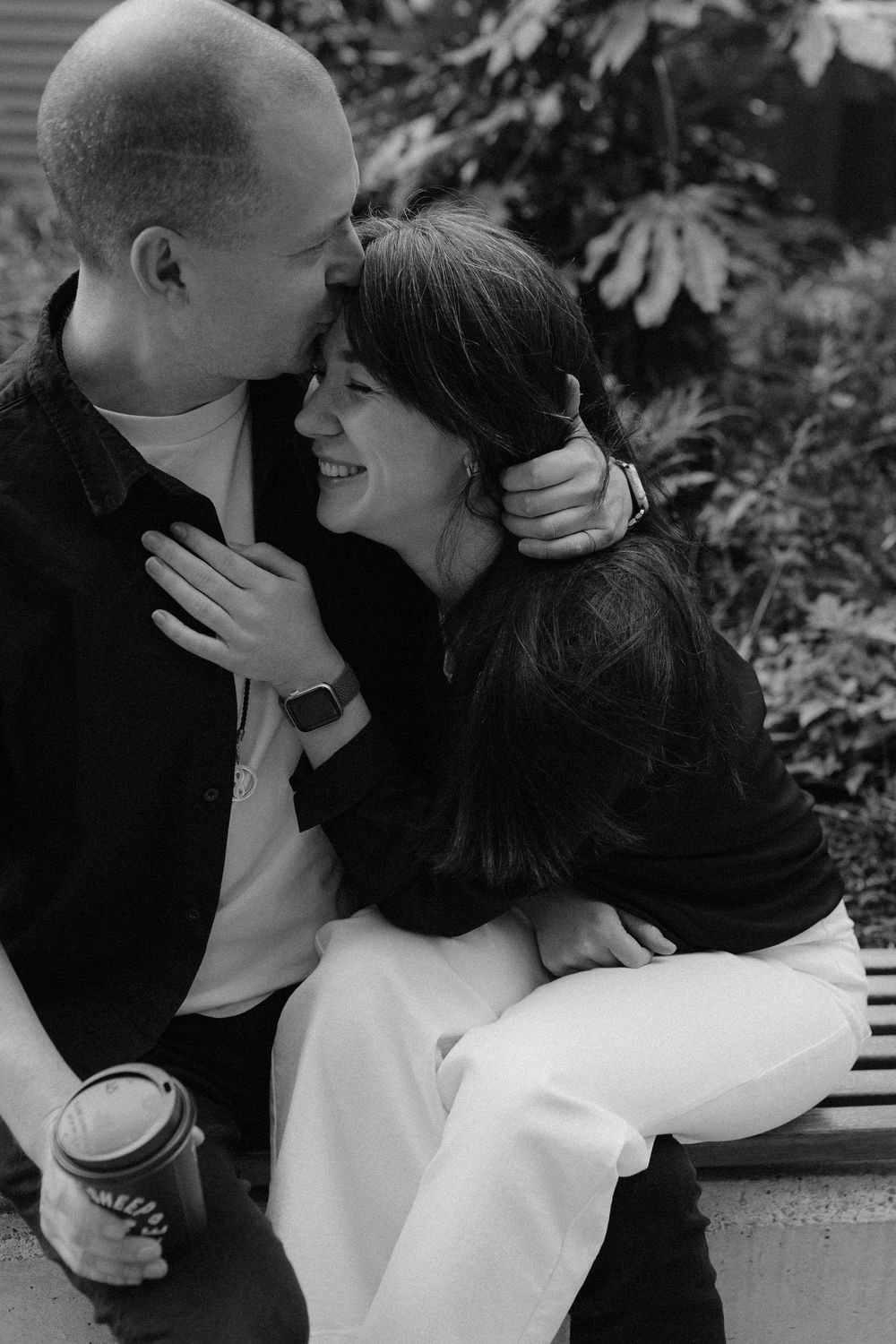 A romantic black and white photo sequence showing an intimate moment between a couple embracing and kissing.