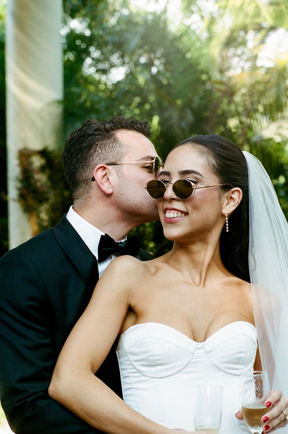 A series of intimate wedding photos showing a couple in white and black attire sharing romantic moments together.