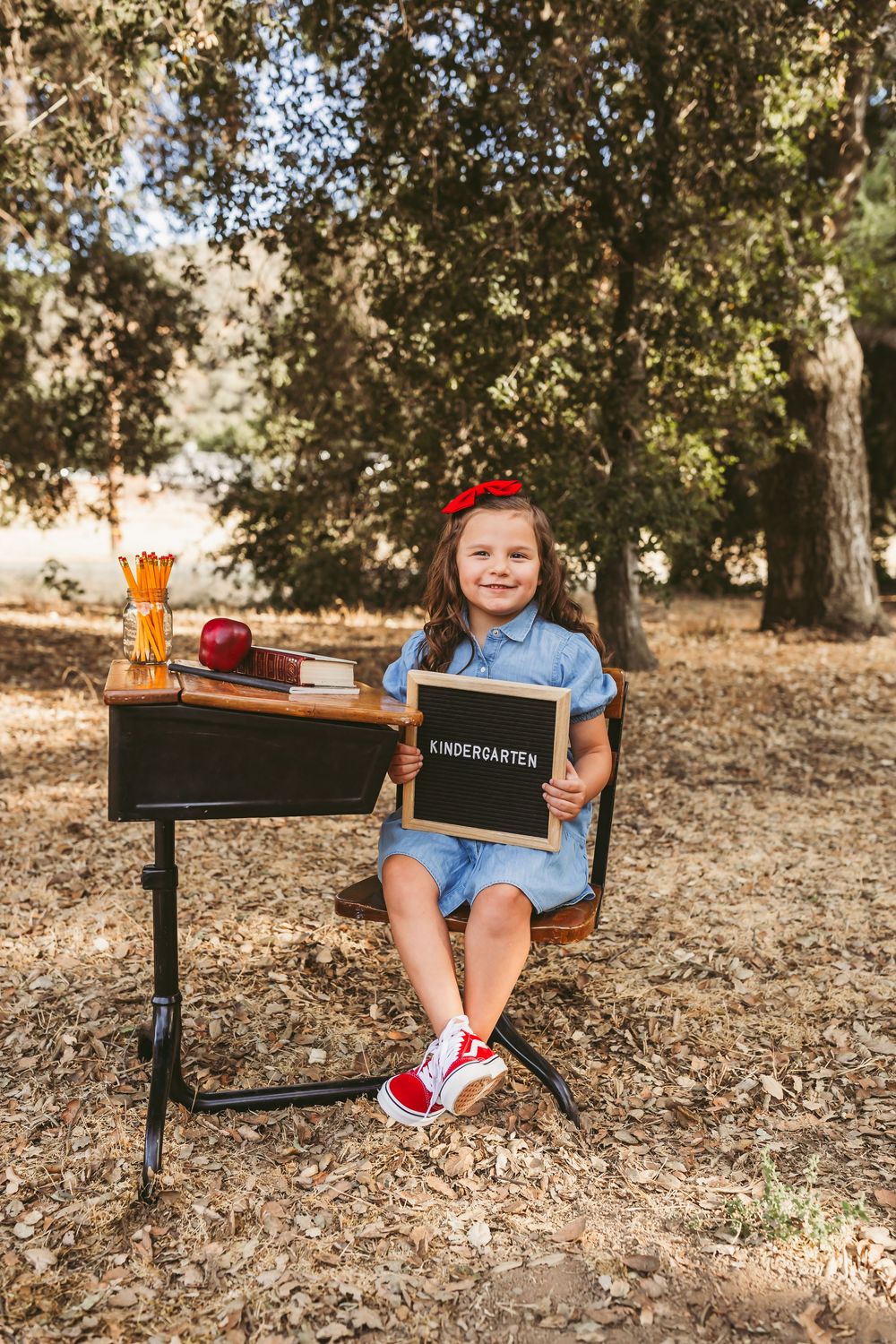 A series of lifestyle photos showing three segments of a wooden desk with a black mailbox against a leafy background.