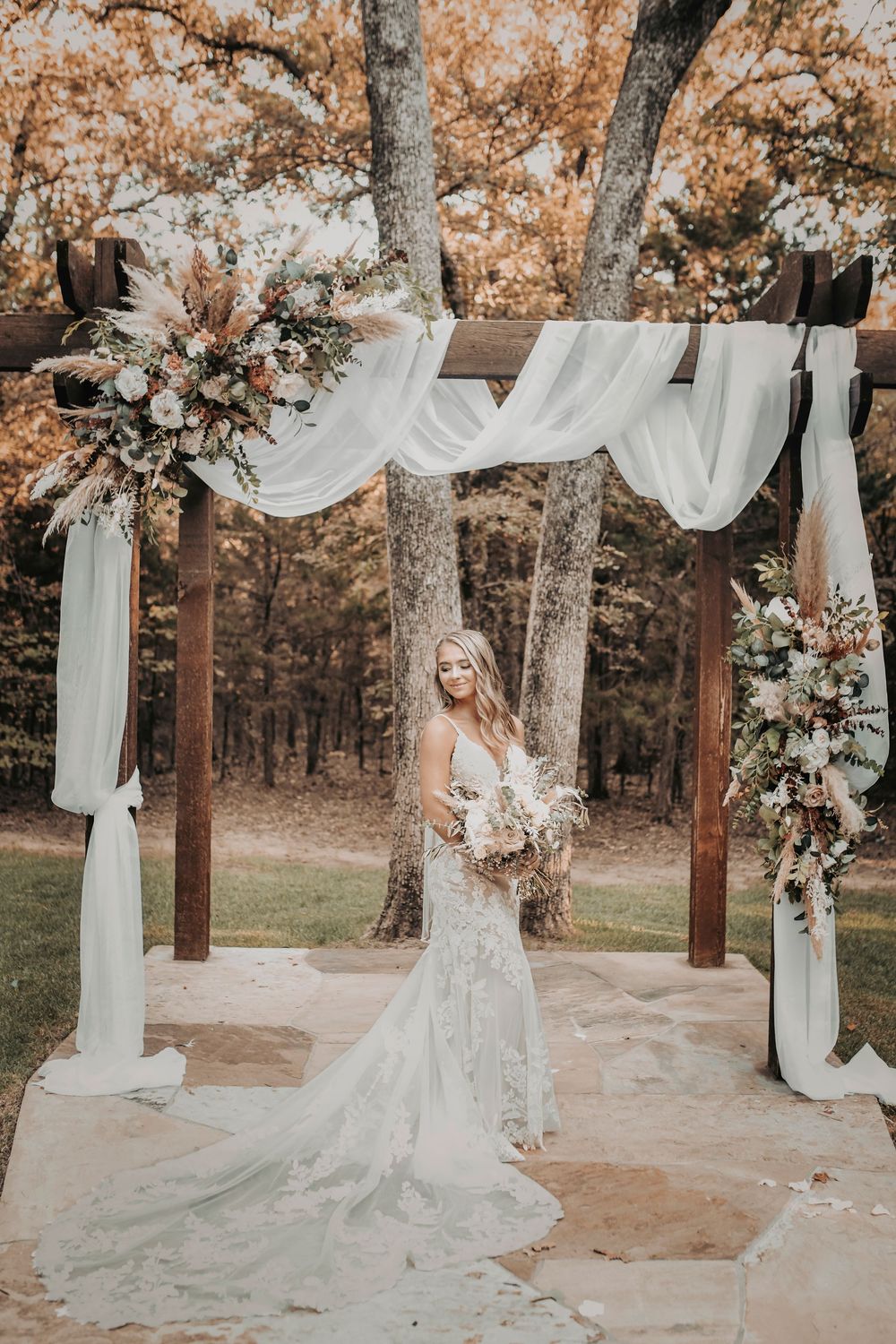 Close-up of bride’s lace gown as she reaches the altar during Whispering Oaks wedding